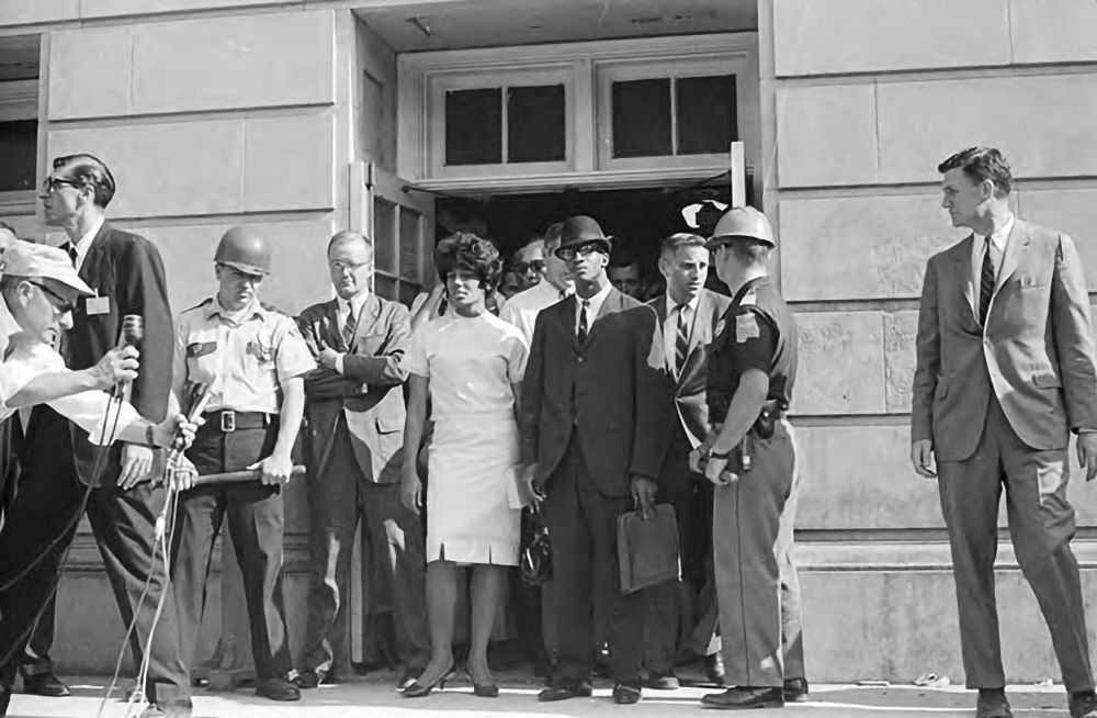 Vivian Malone and James Hood stand in the doorway of Foster Auditorium.