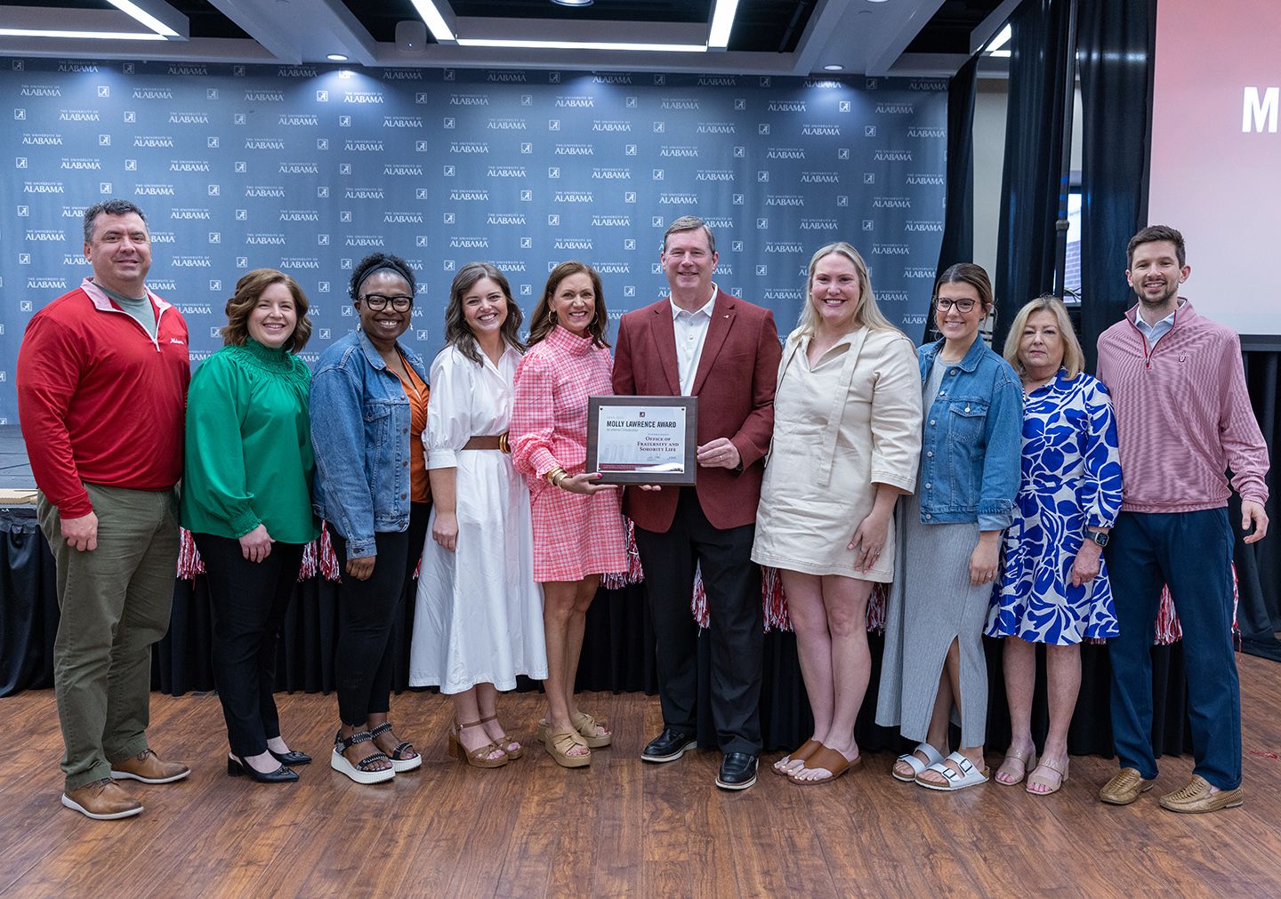 Group from OFSL holds the award and poses for a picture with dr hood