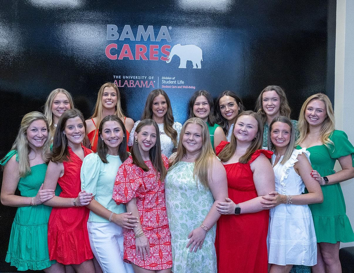 Alpha Gamma Delta group photo in front of pantry