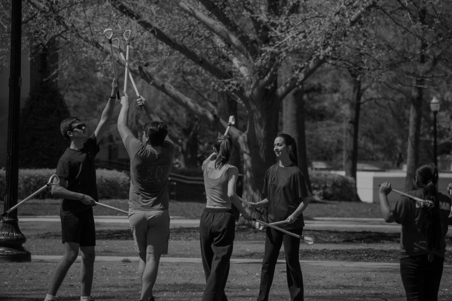a group of students playing a game with sticks