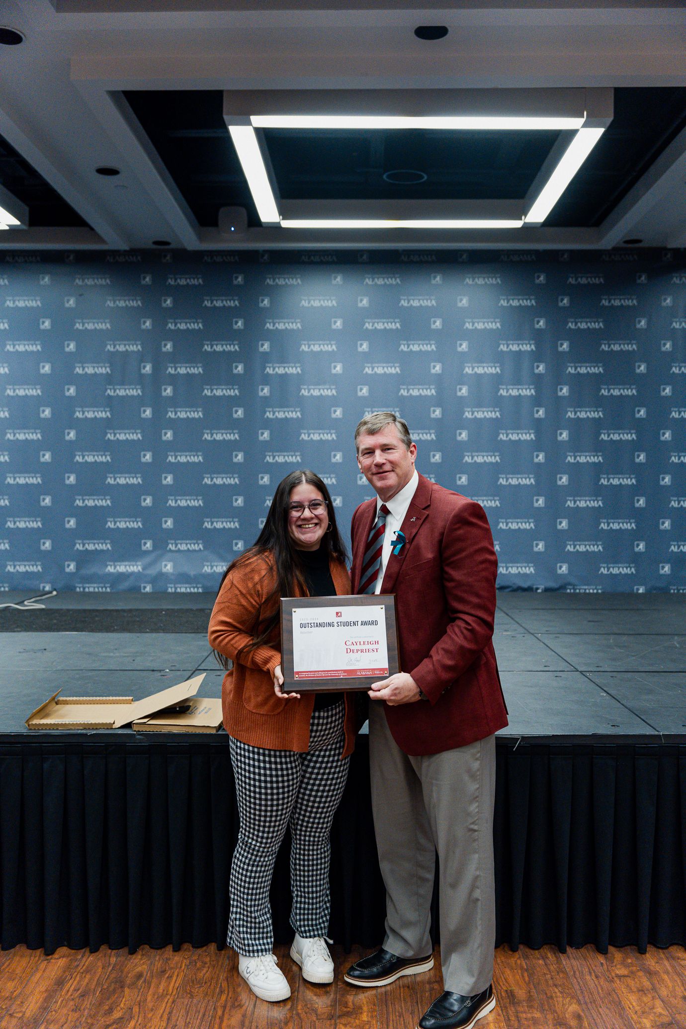cayleigh depriest holds the award and poses for a picture with dr hood
