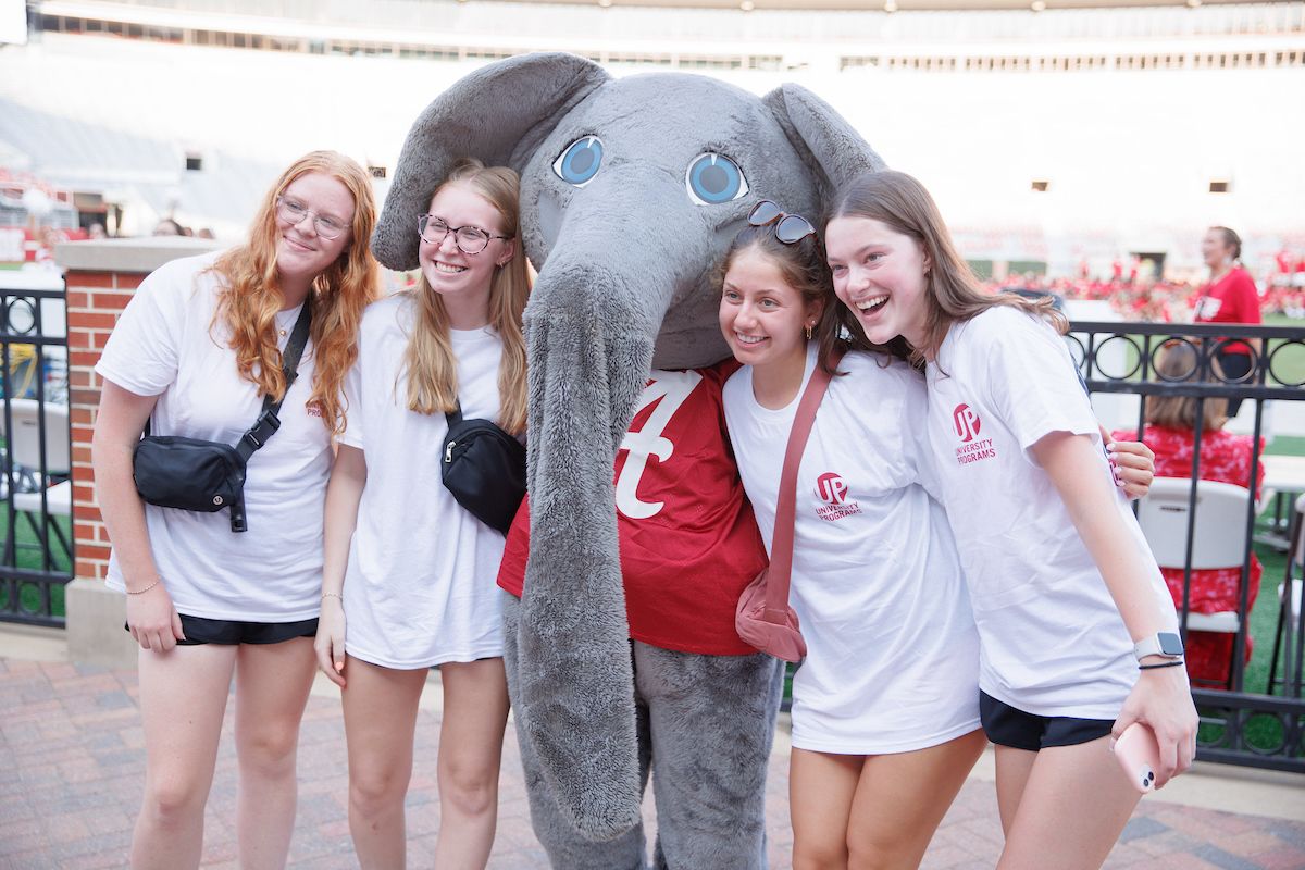 students pose for a photo with big al the elephant mascot