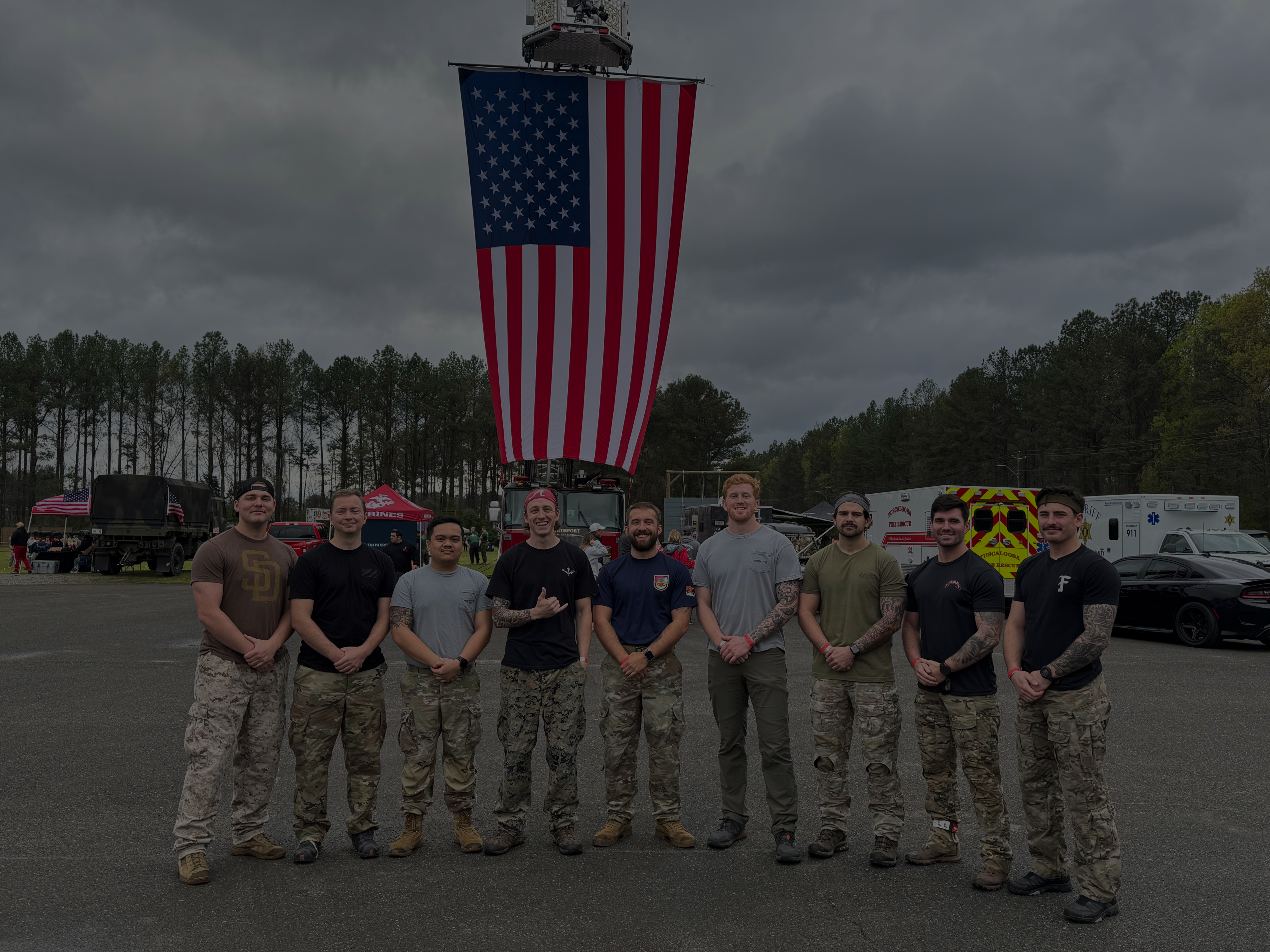 a group of student veterans pose for a photo with an american flag