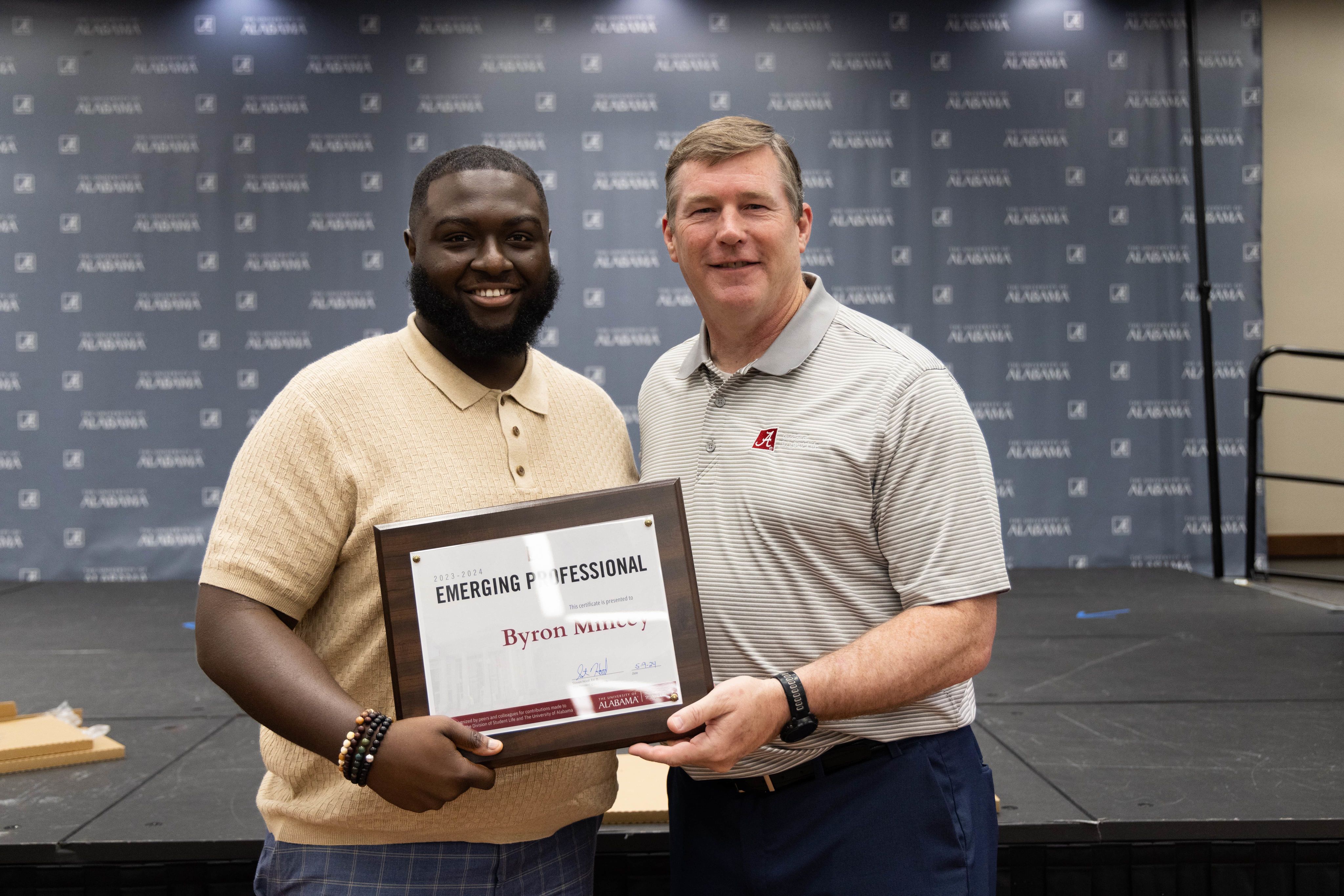 byron mincey holds the award and poses for a picture with dr hood