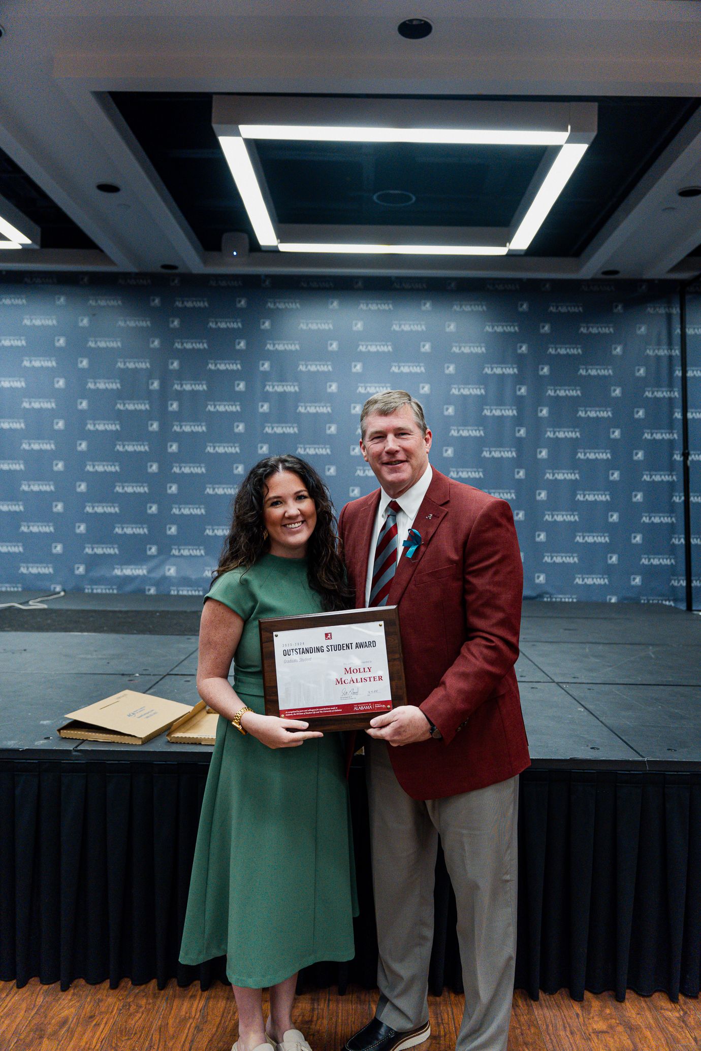 molly mcalister holds the award and poses for a picture with dr hood
