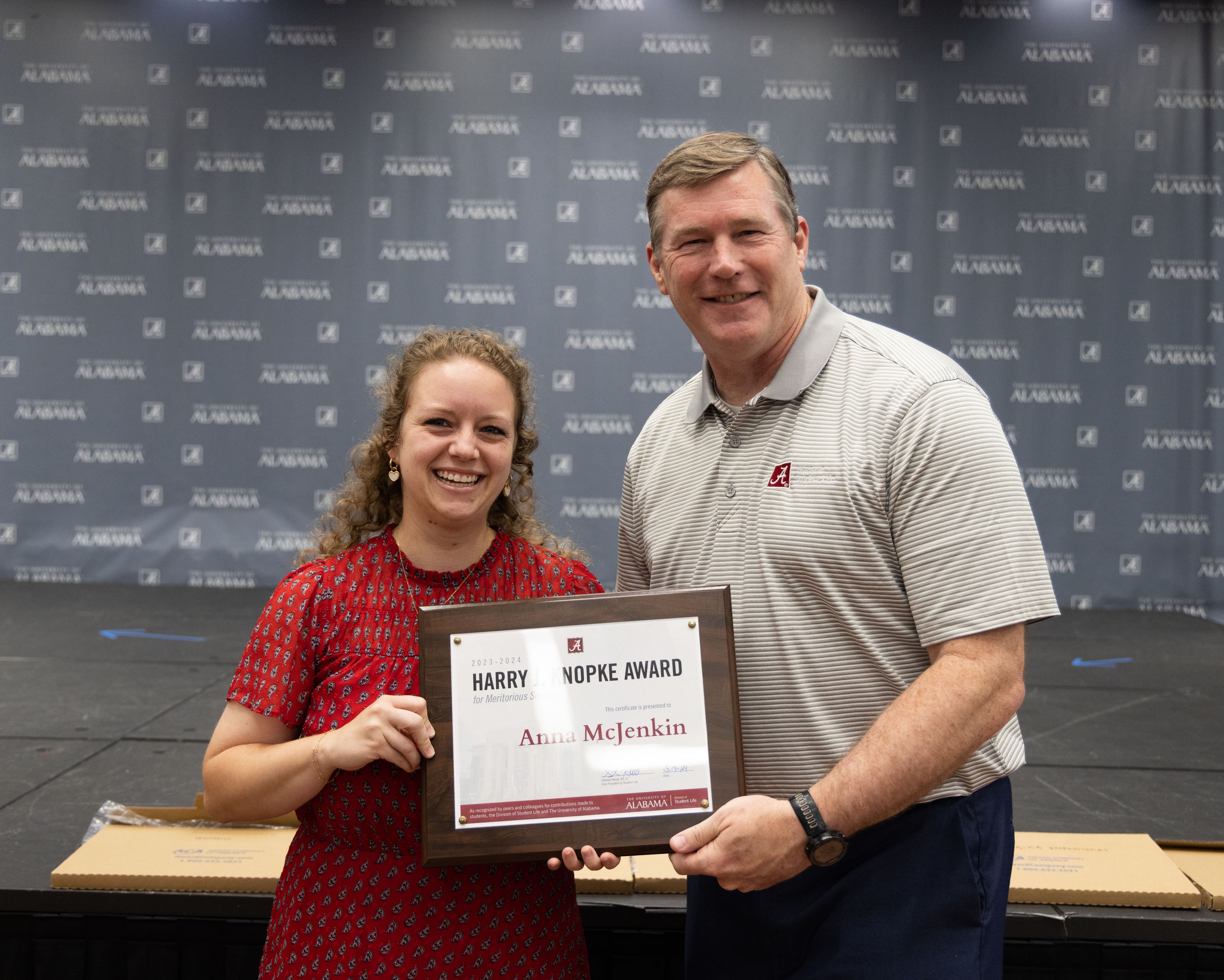 anna mcjenkin holds the award and poses for a picture with dr hood