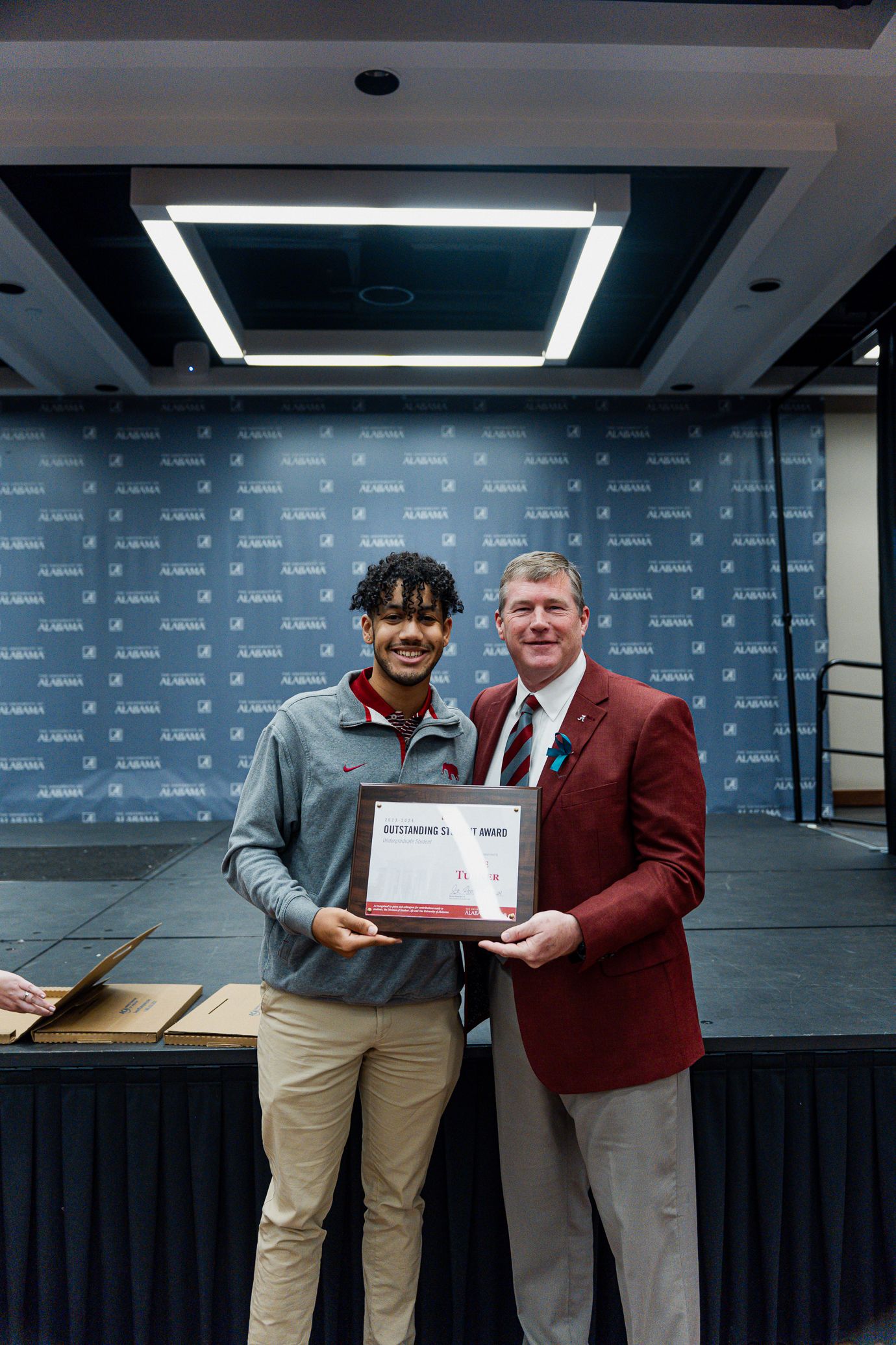 tre turner holds the award and poses for a picture with dr hood