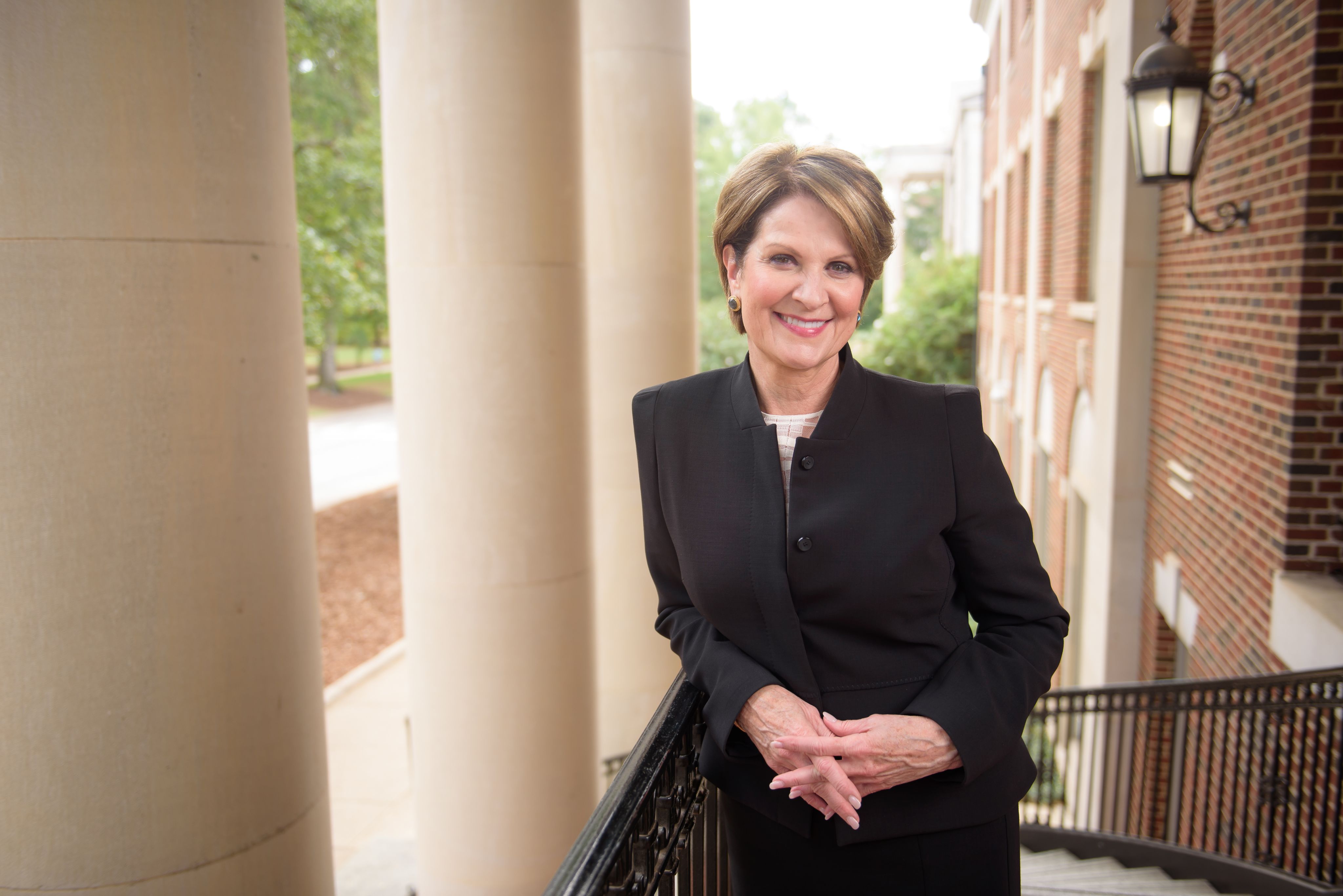 Marillyn Hewson posing by a column.