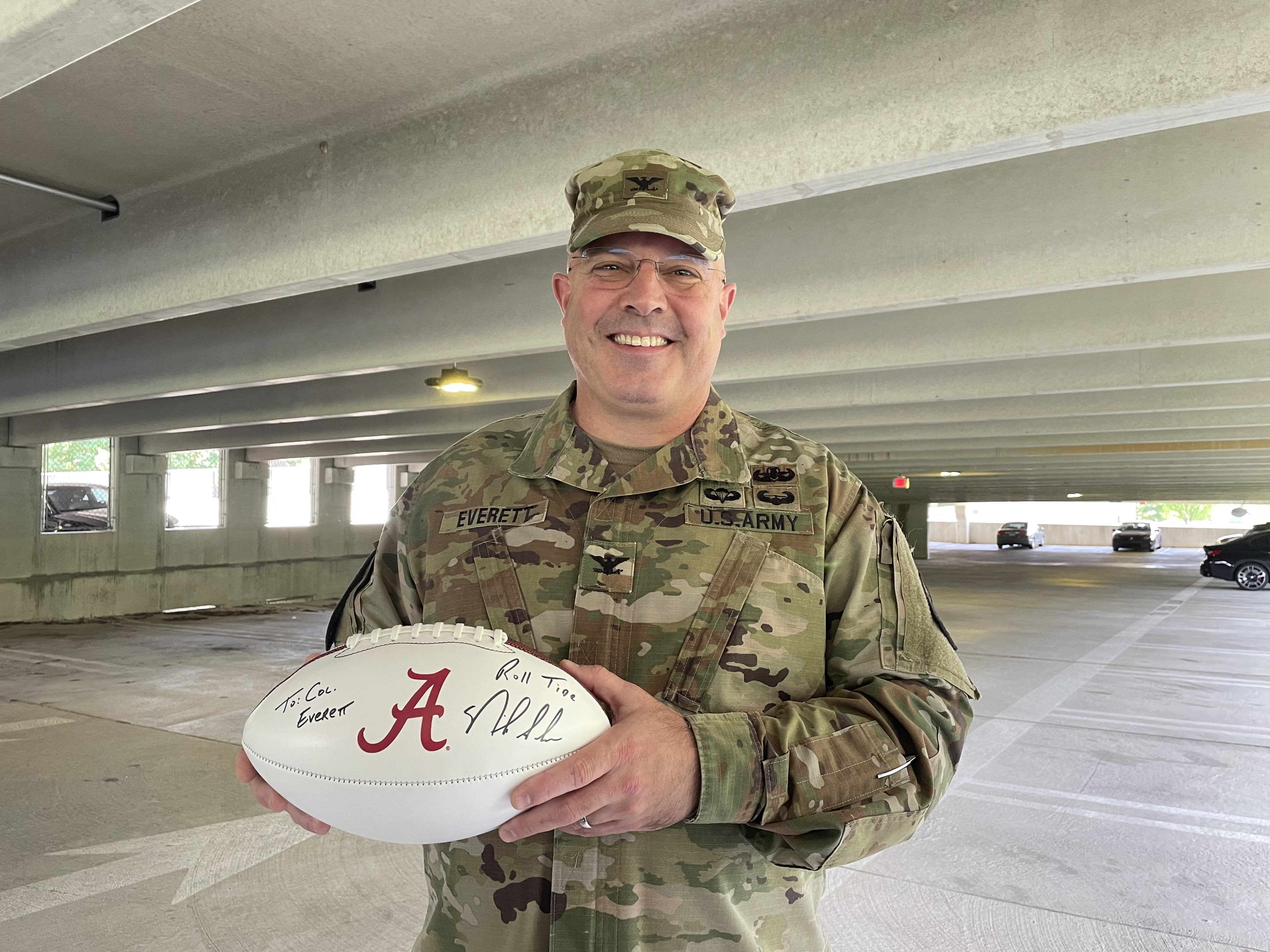 Daniel Everett with his Alabama football signed by Nick Saban.