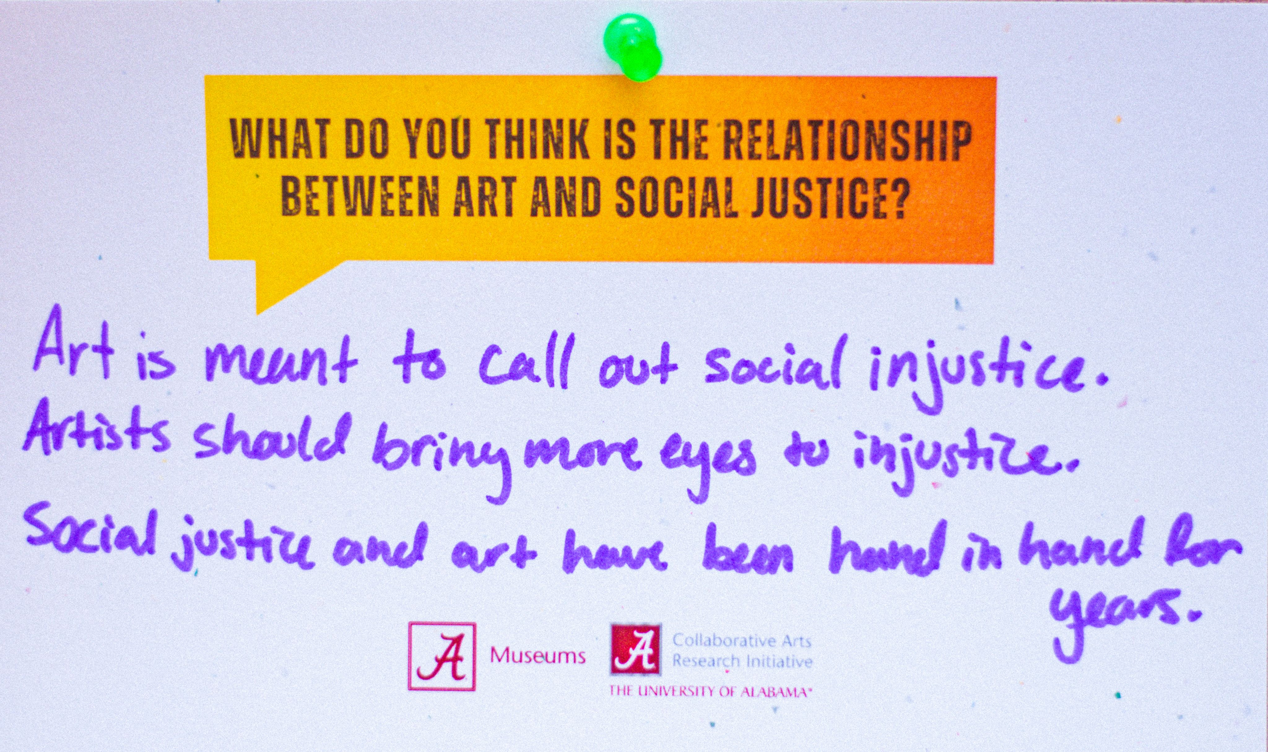 Card featuring a question in a yellow speech bubble, asking 'What do you think is the relationship between art and social justice?' with handwritten notes below discussing the role of art in highlighting social injustice. Logos of The University of Alabama Museums and the Collaborative Arts Research Initiative at The University of Alabama are visible.