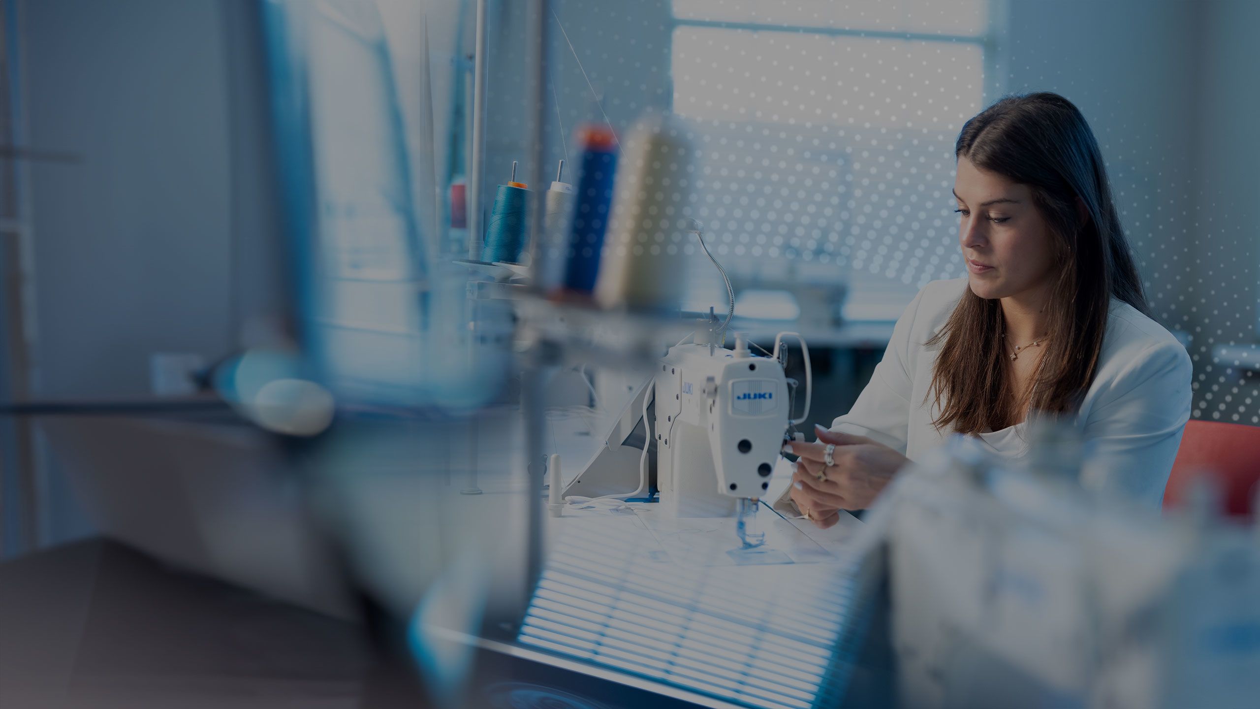 Laken Thompson working at a sewing machine.