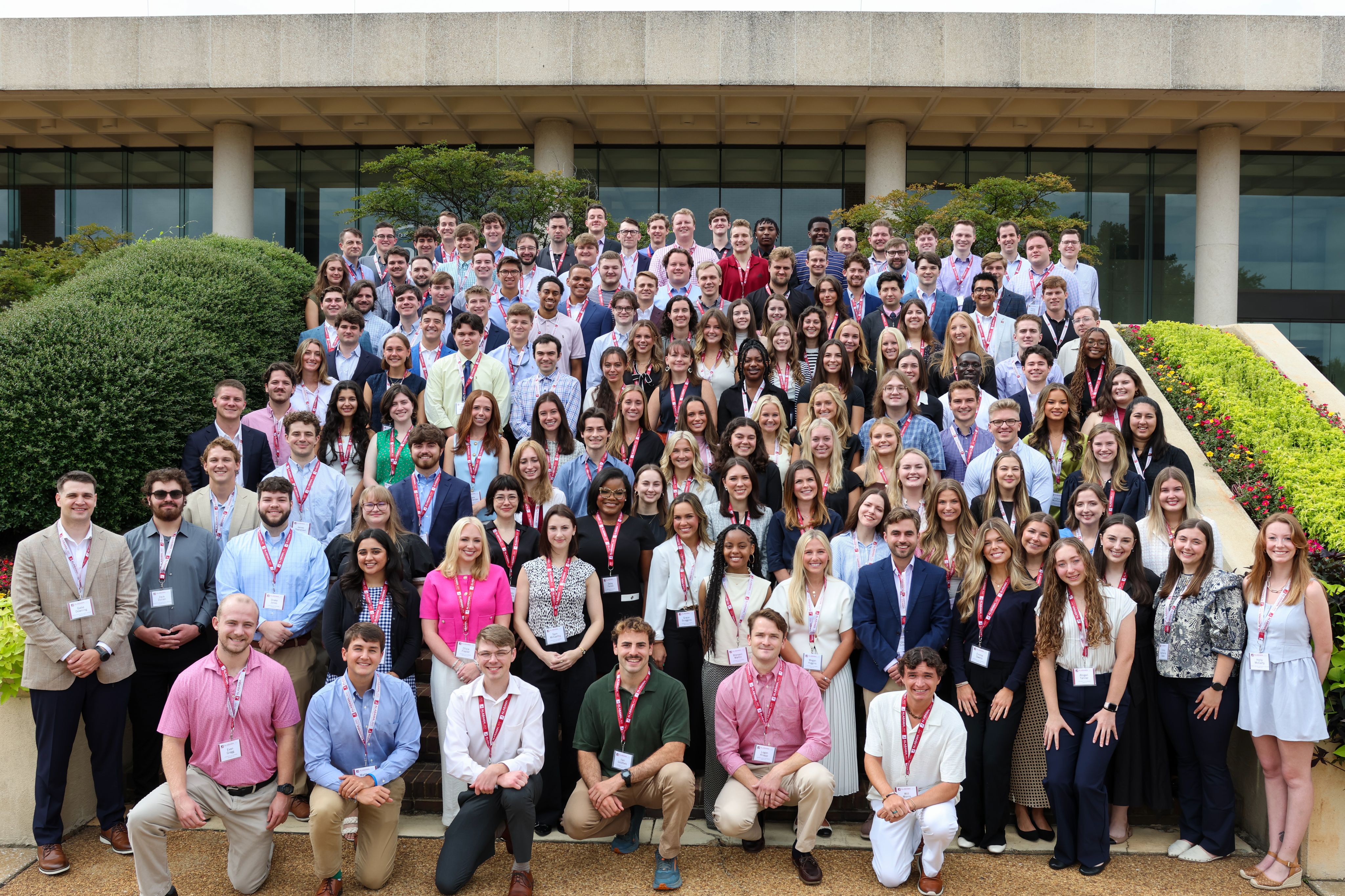 A large group of students on the front steps of a school building.