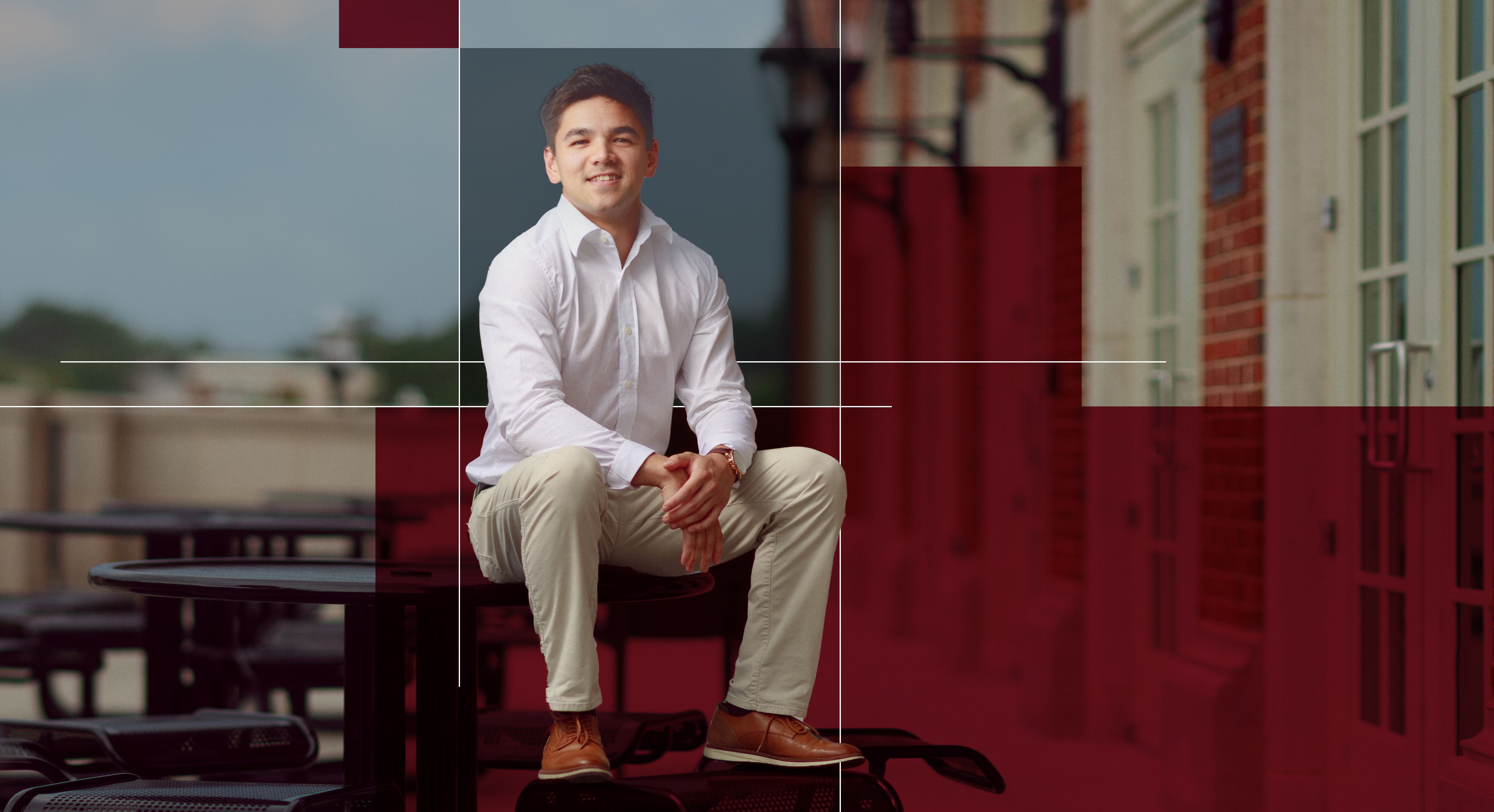 Nathan sits on a table outside of Hewson Hall