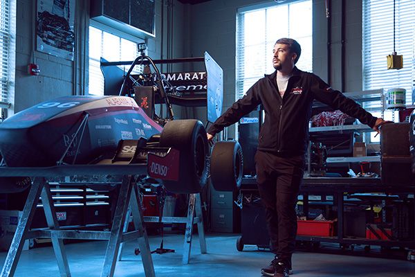 Cole Frederick with the UA Racing team car.