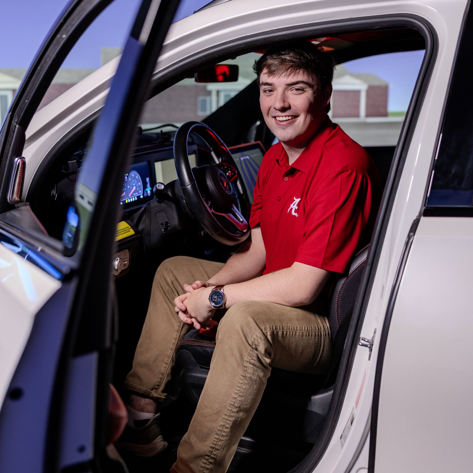 UA student, Price Ledbetter, sitting in a vehicle