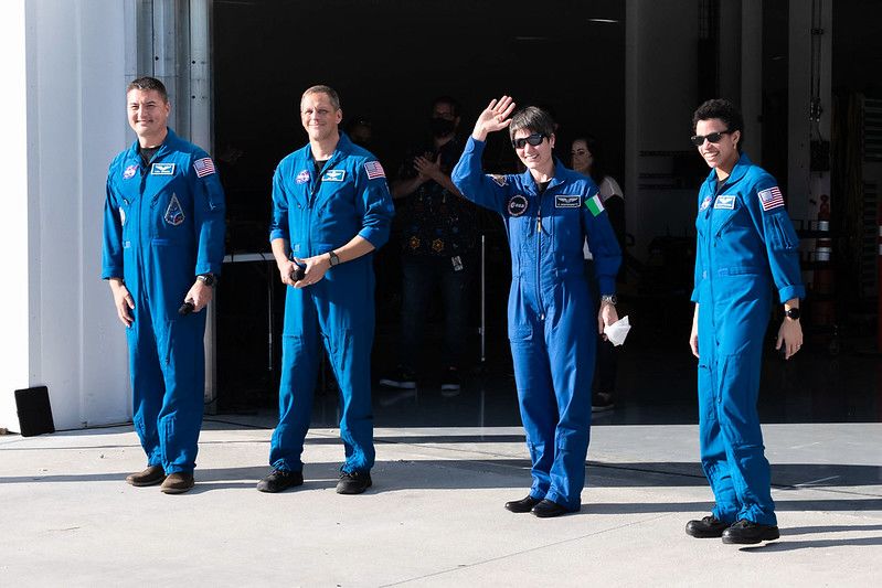 Hines and his three crewmates pose for photos outside a hangar