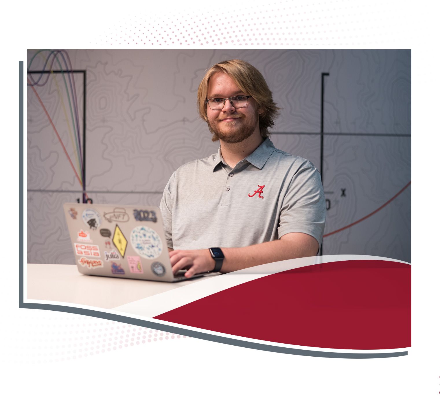 Brodie Alexander working on a laptop while sitting at a table.