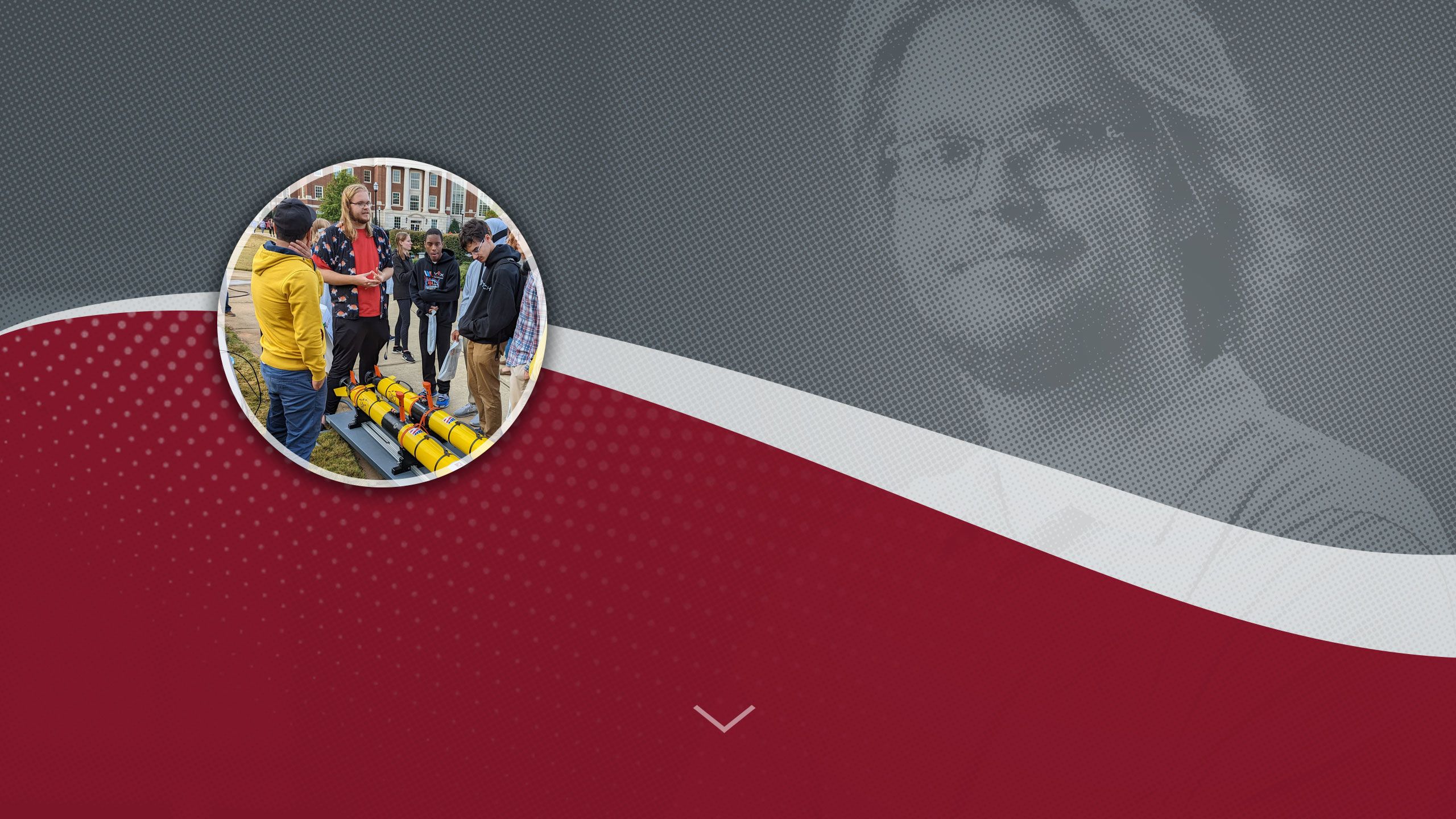 Brodie Alexander poses with a group of students looking at a project.