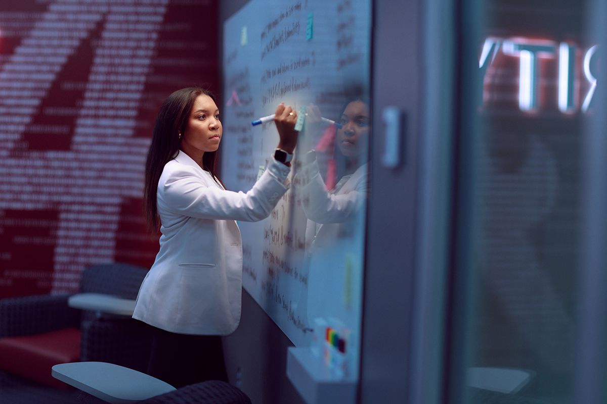 Profile photo of Summer Davis writing on a whiteboard
