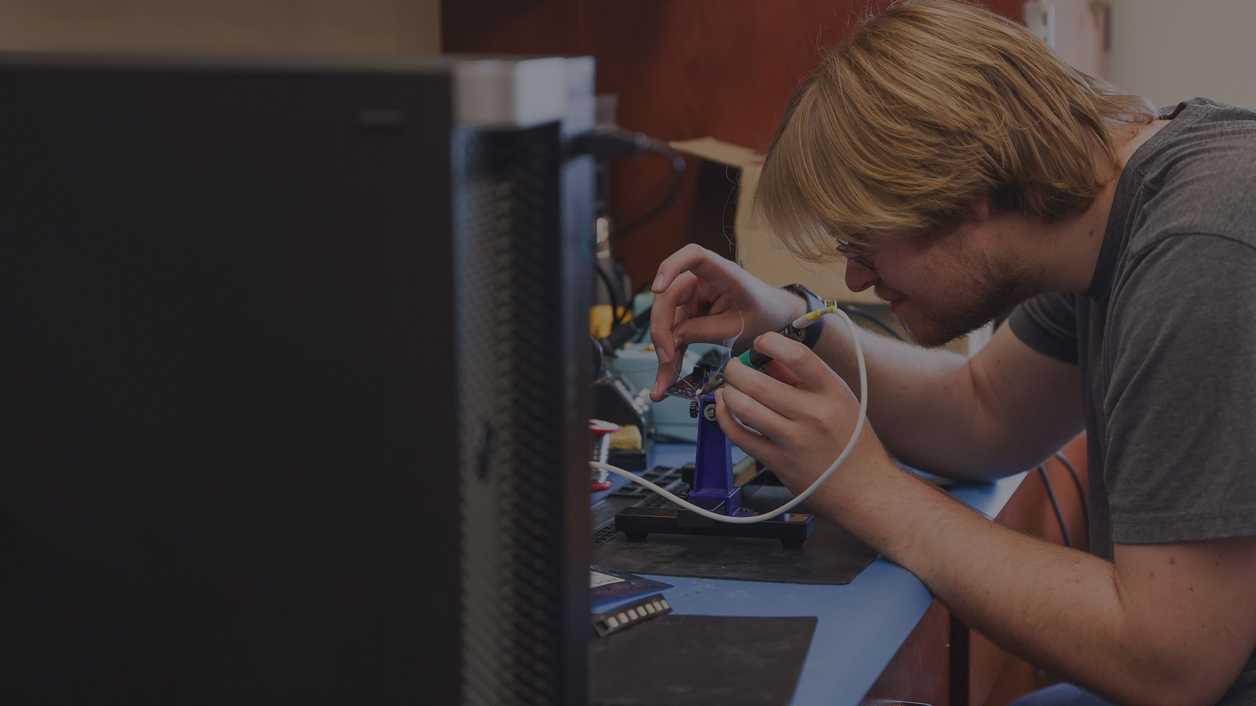 Brodie Alexander soldering in a lab.