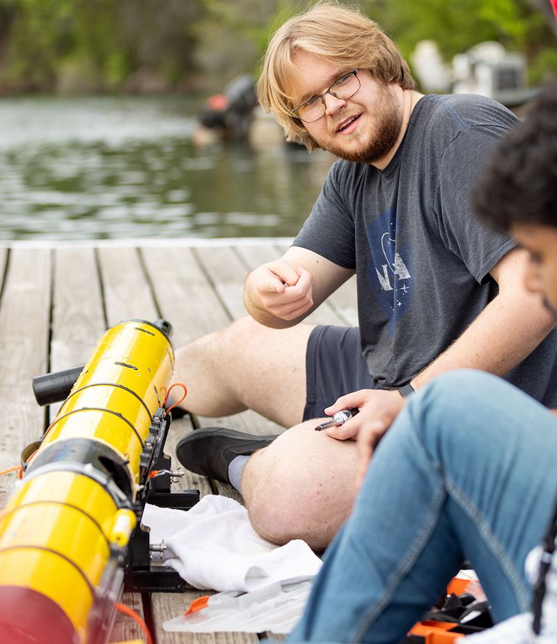 Brodie Alexander discusses a project with a fellow student