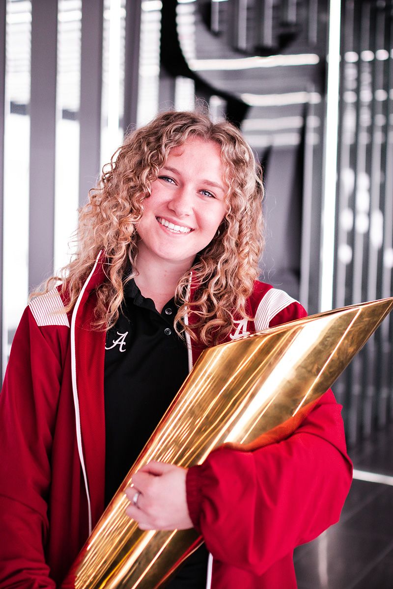 Emily Henderson poses with the college football playoff trophy
