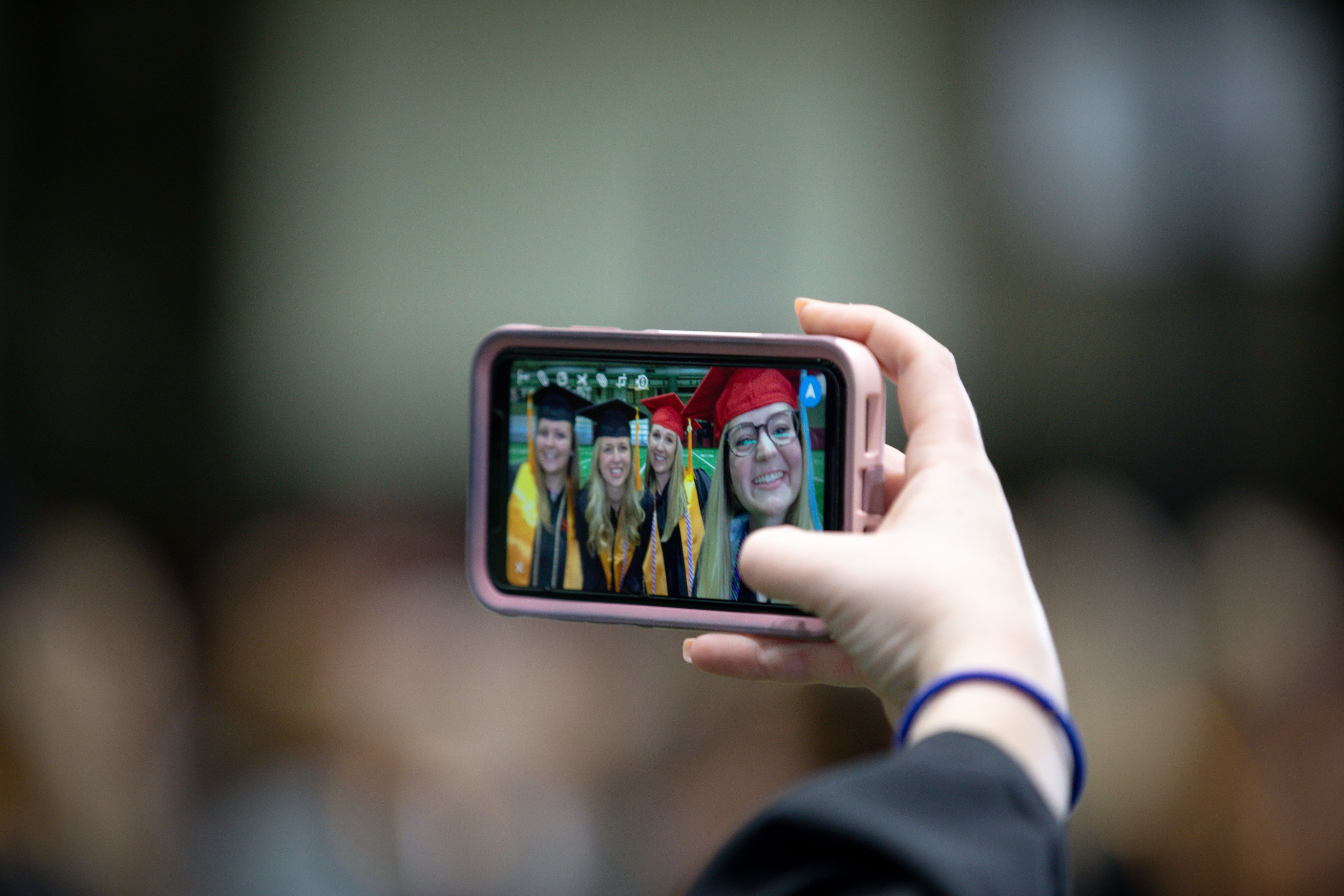 Students taking a selfie at graduation