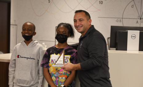 Photo of Dr. Mike Daria presenting an award at the 2022 MATHCOUNTS competition.