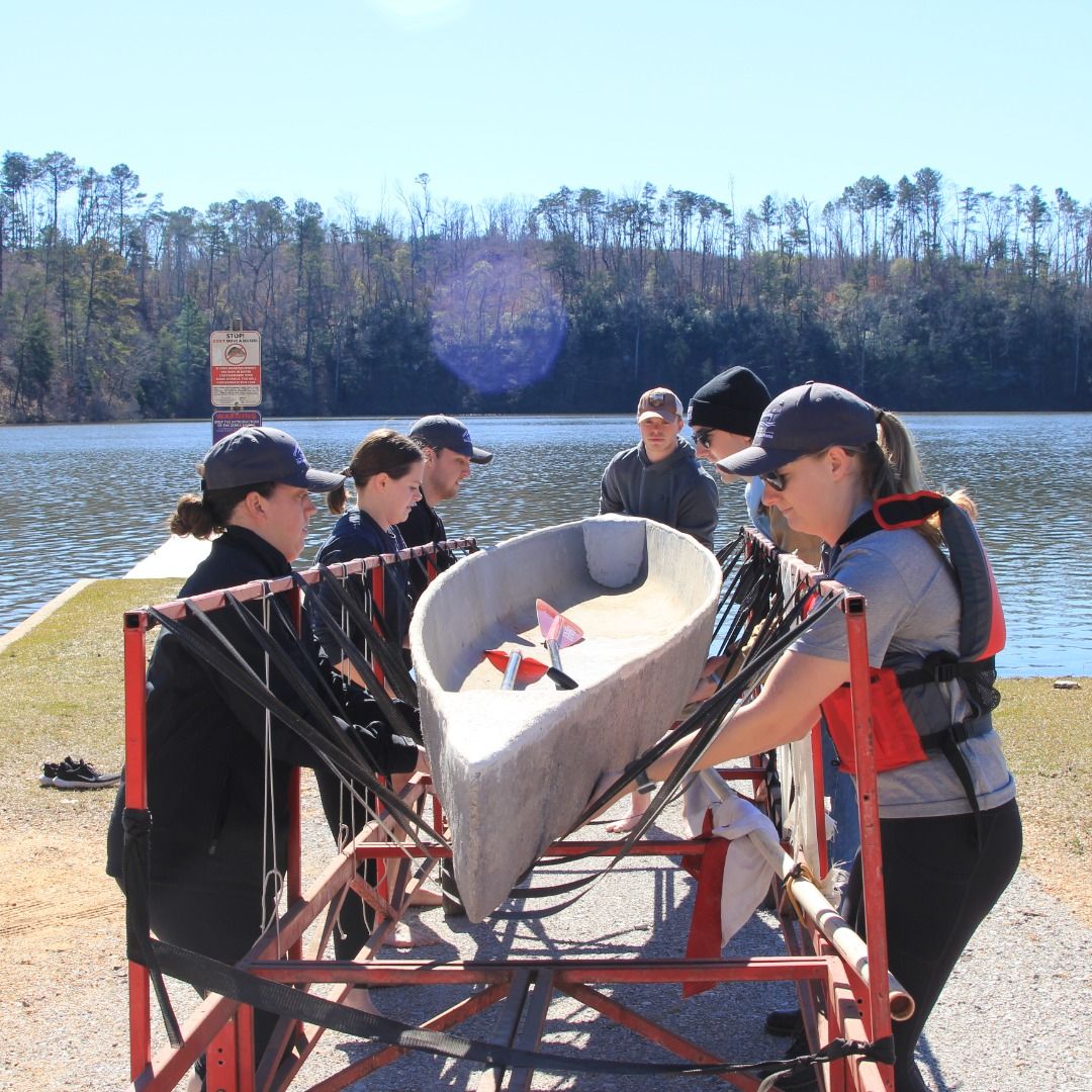 Team members preparing to test their canoe for the first time.