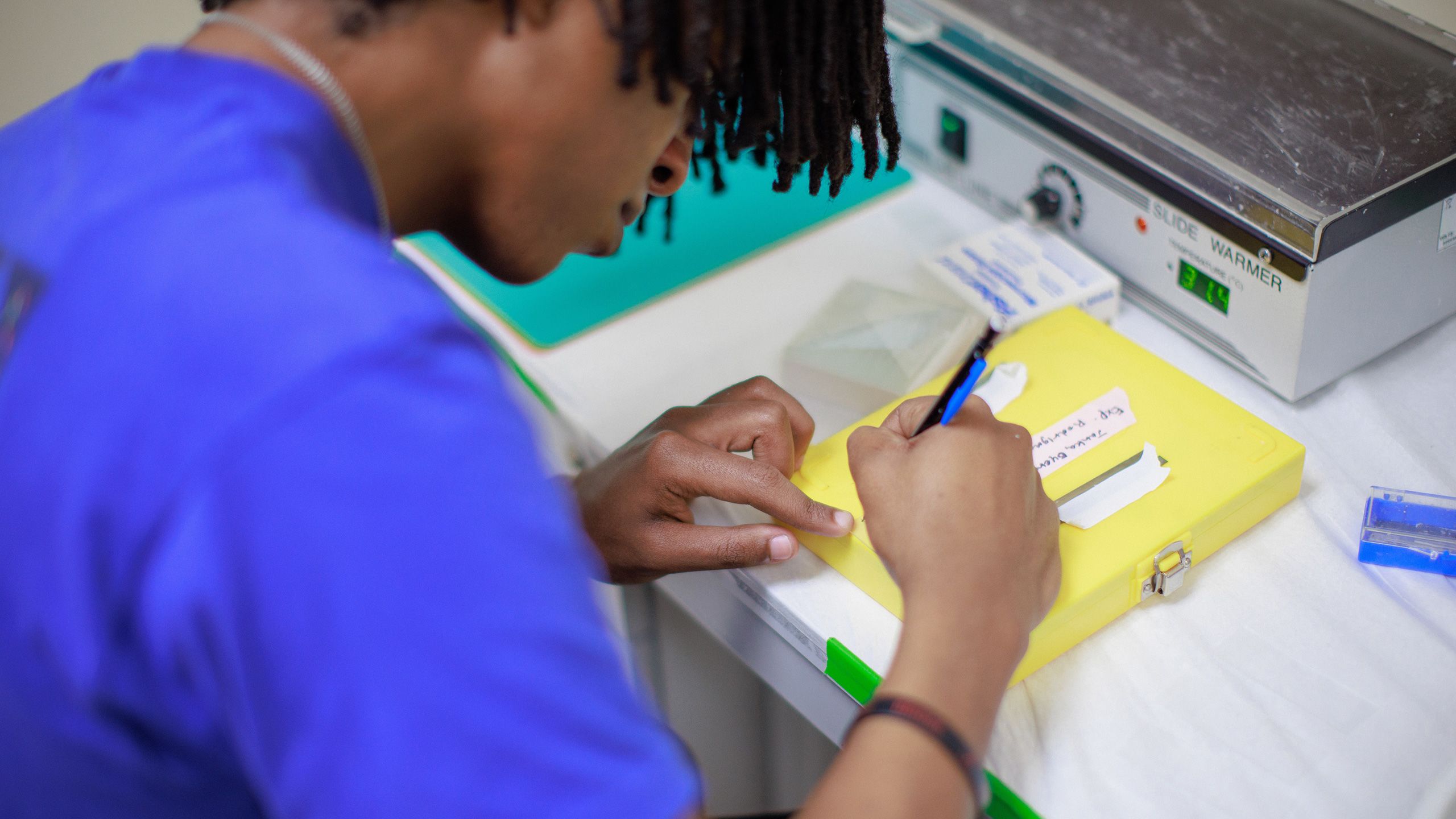Yonathan Janka writing in a research lab