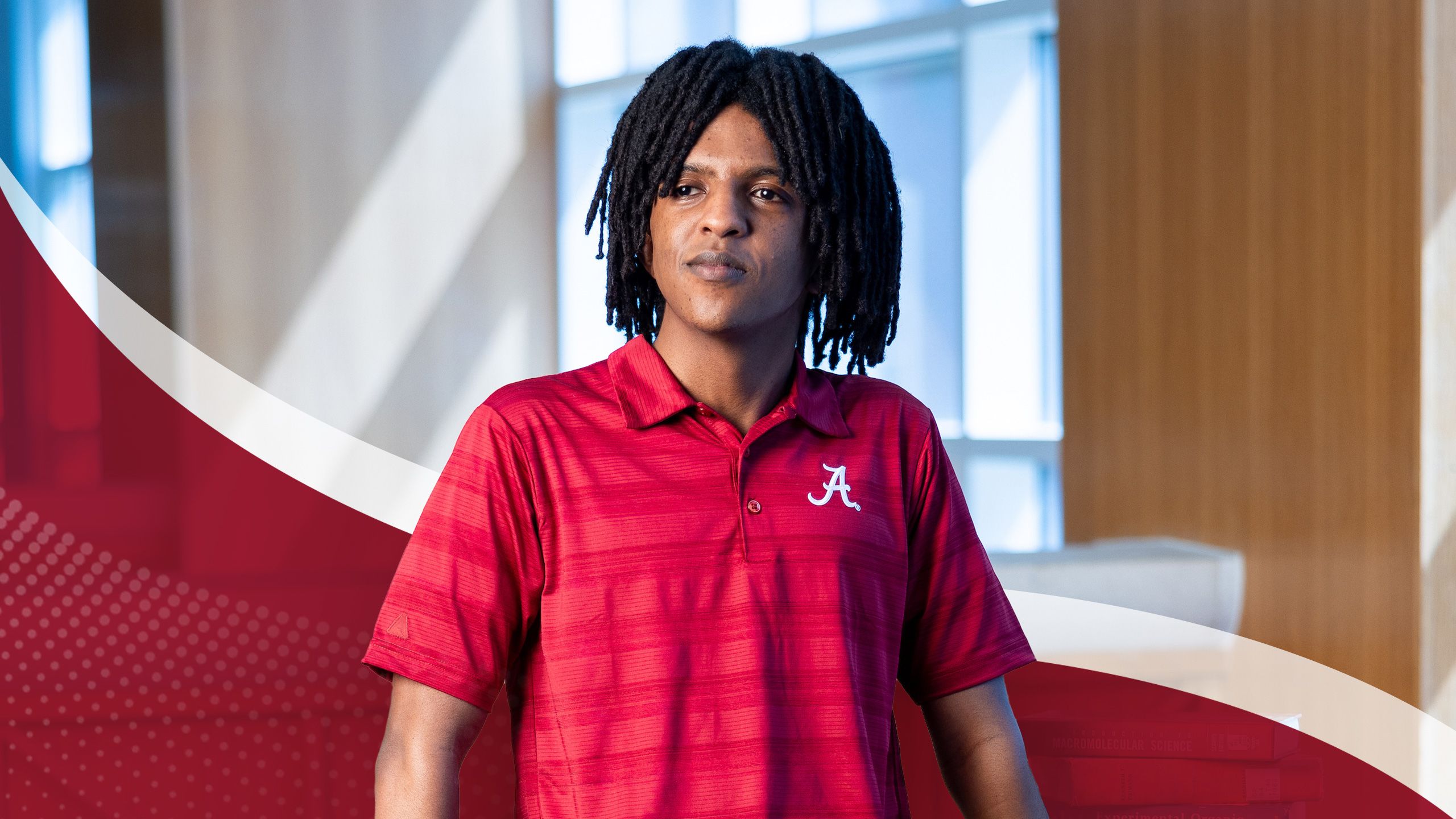 Yonathan Janka posing in a University of Alabama building.