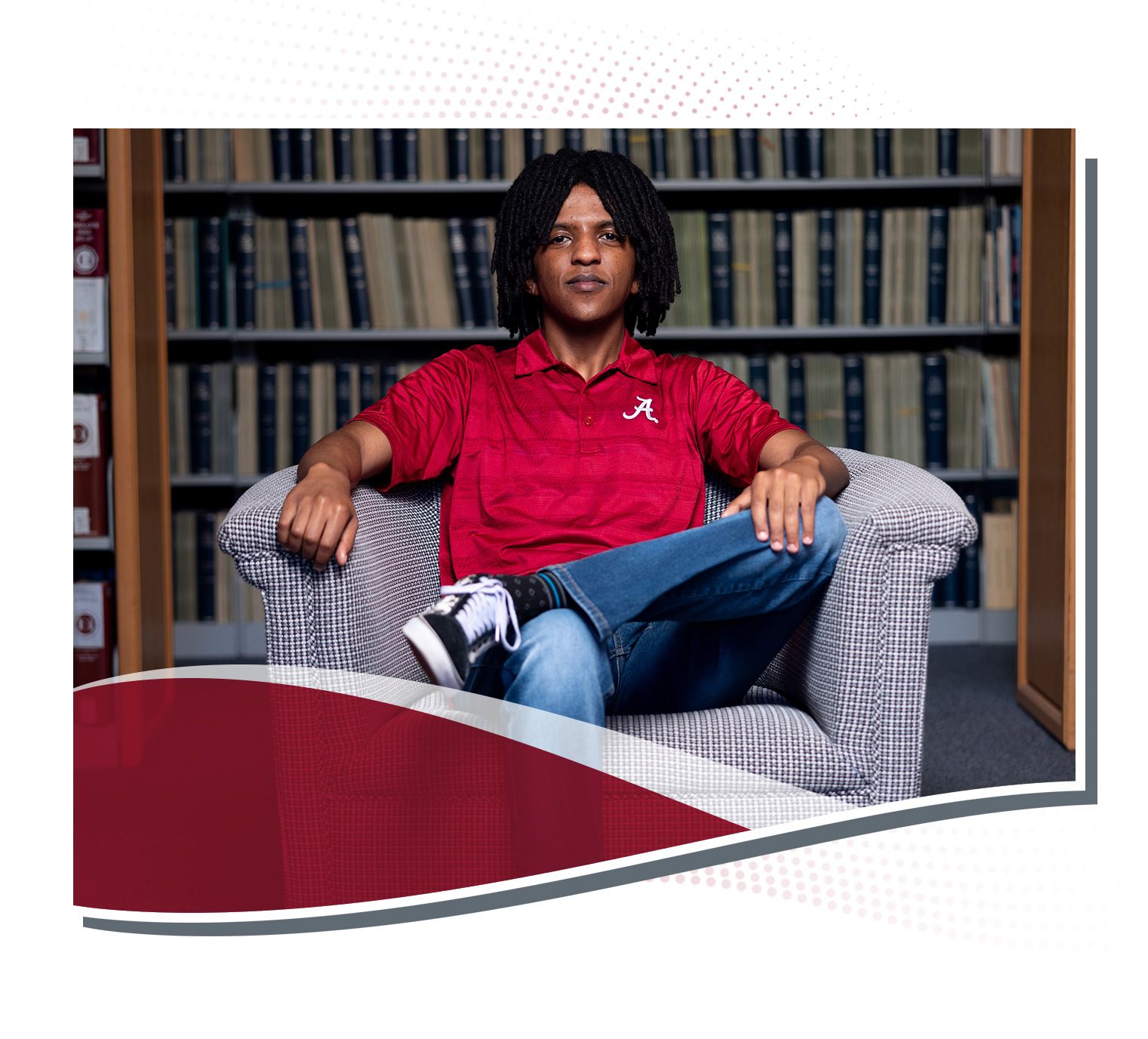 Yonathan Janka sitting in a chair in a University of Alabama library.