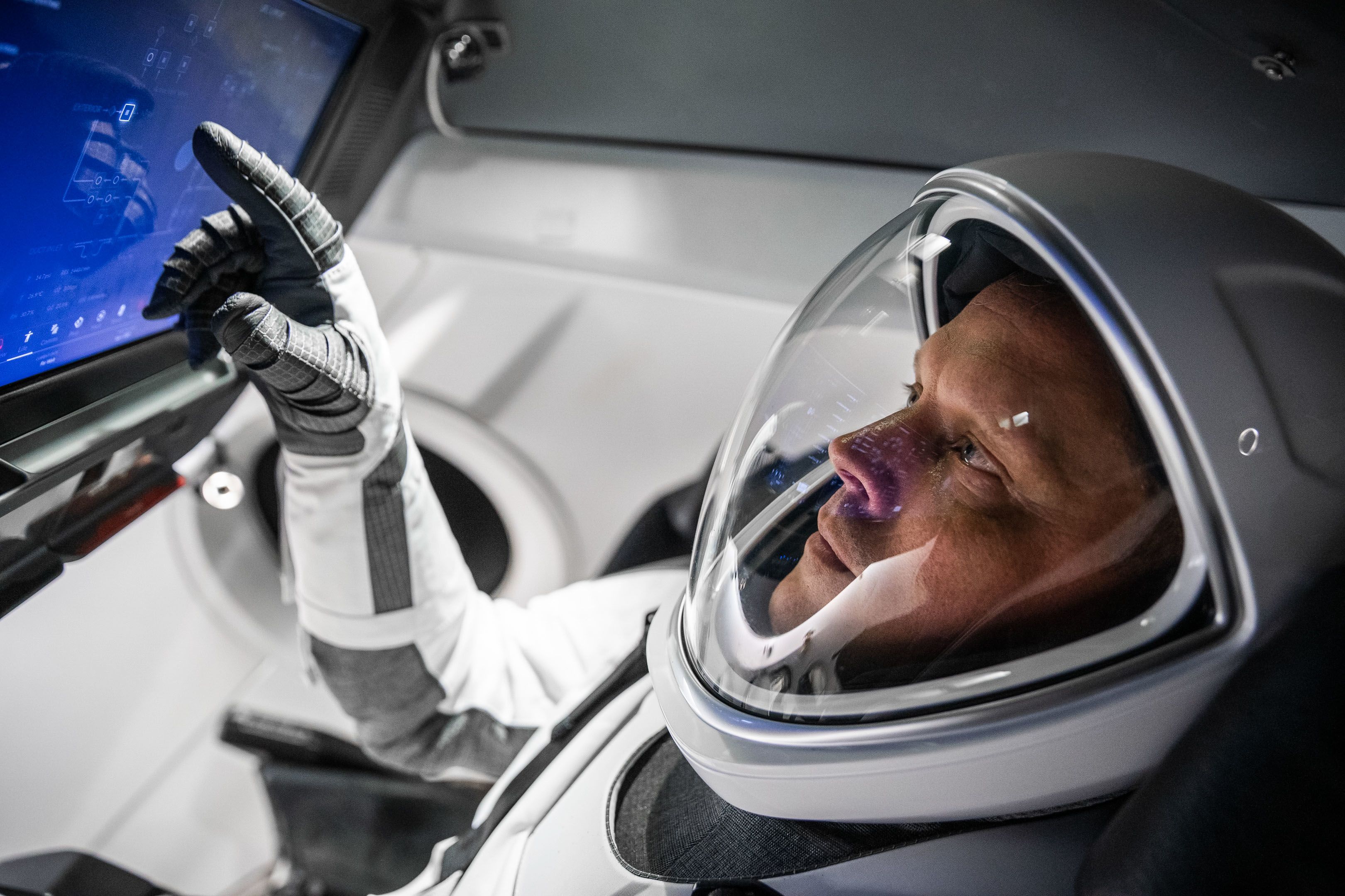 Commander Hines interacts with a touchscreen on the spacecraft