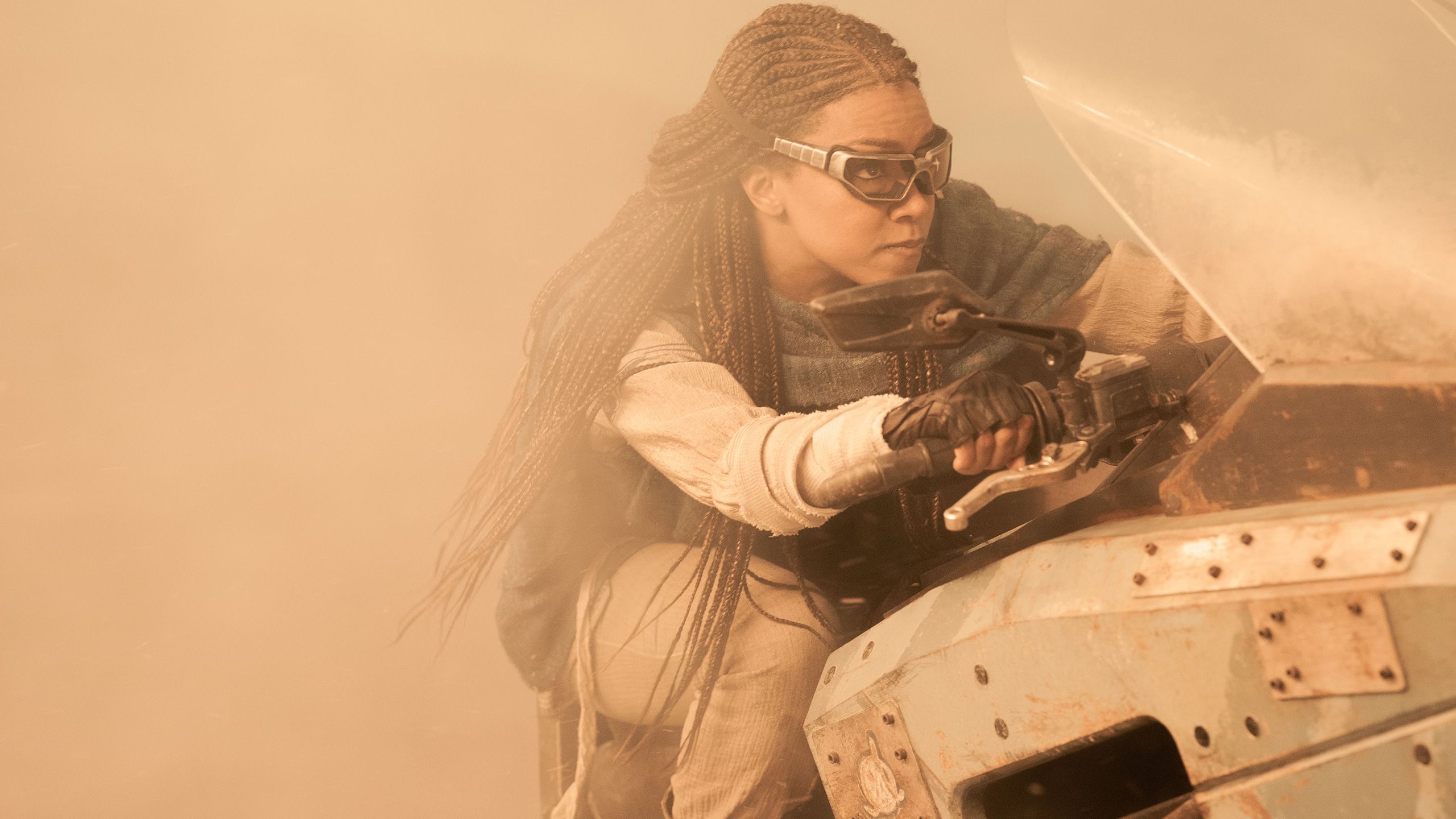 Sonequa Martin-Green riding a vehicle in a movie project.