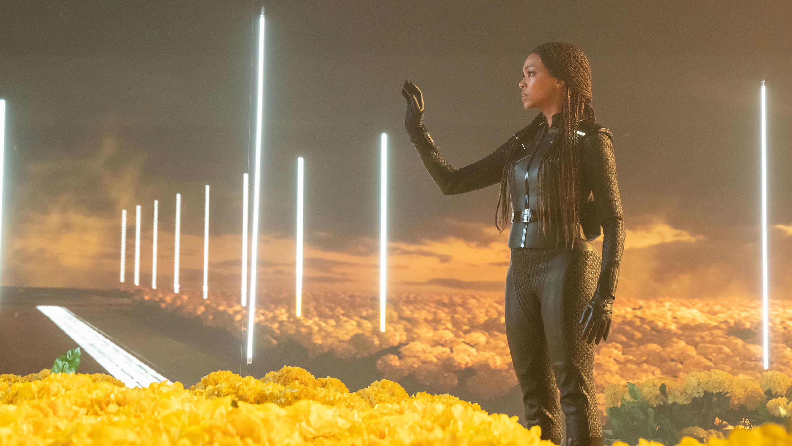 Sonequa Martin-Green standing in a yellow landscape from a movie project.