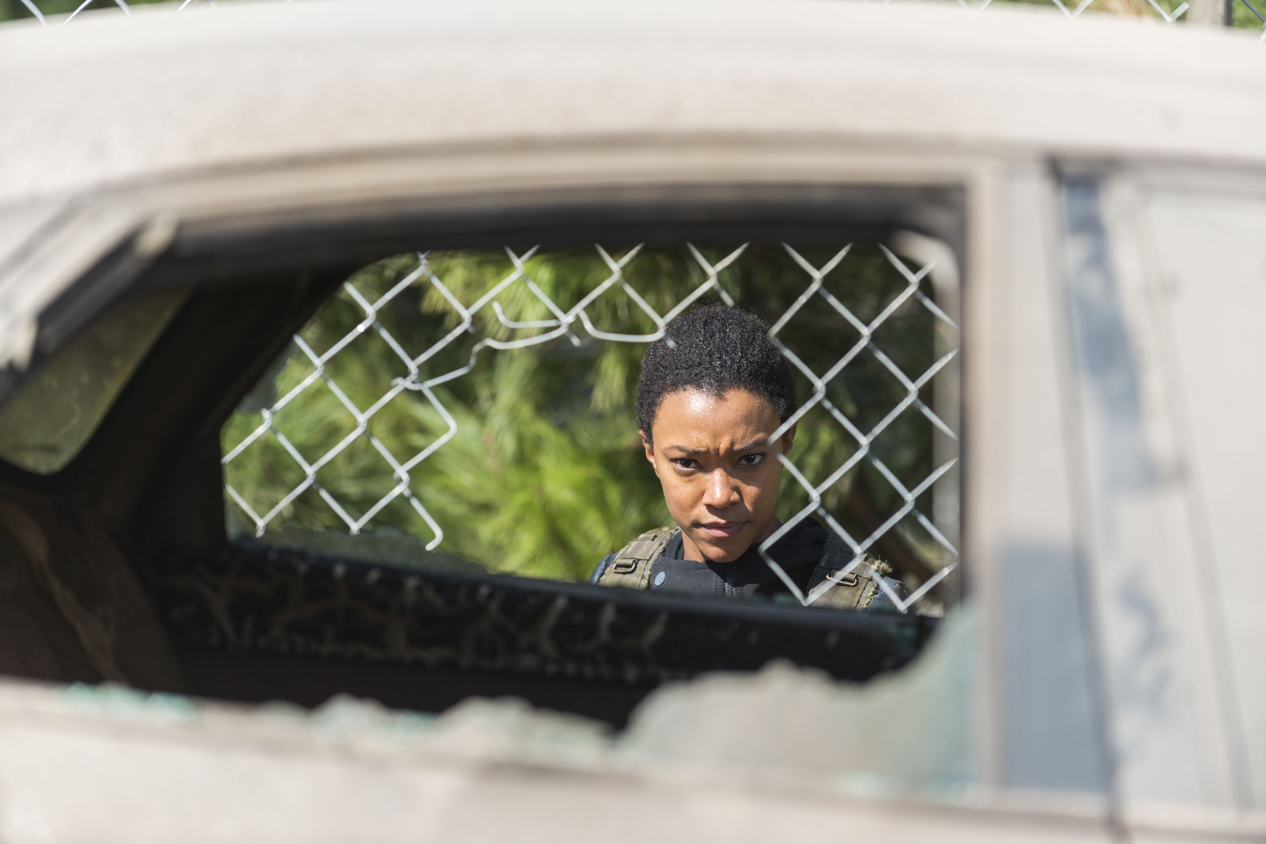 Sonequa Martin-Green looking through the window of a car on the AMC television show, The Walking Dead.