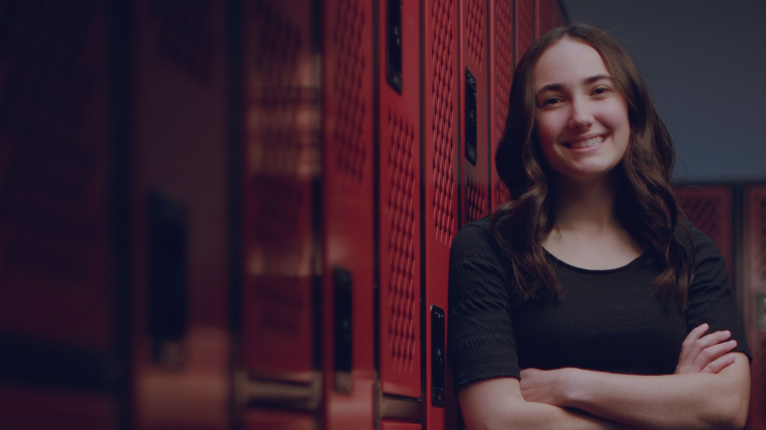 Brittany Grigorian leans on some lockers in a UA training room.