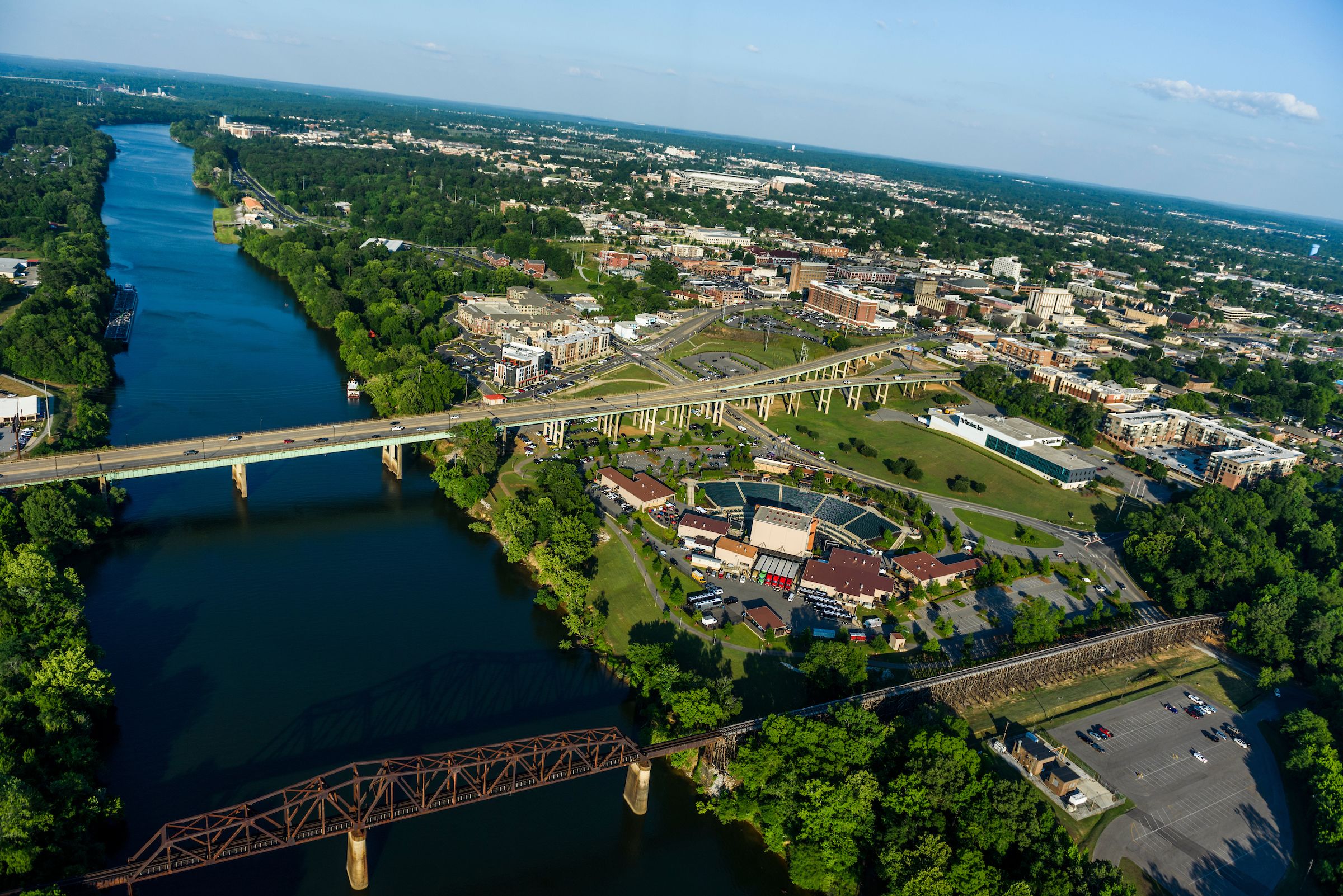 Aerial shot of Tuscaloosa showcasing the Black Warrior River alongside the city.