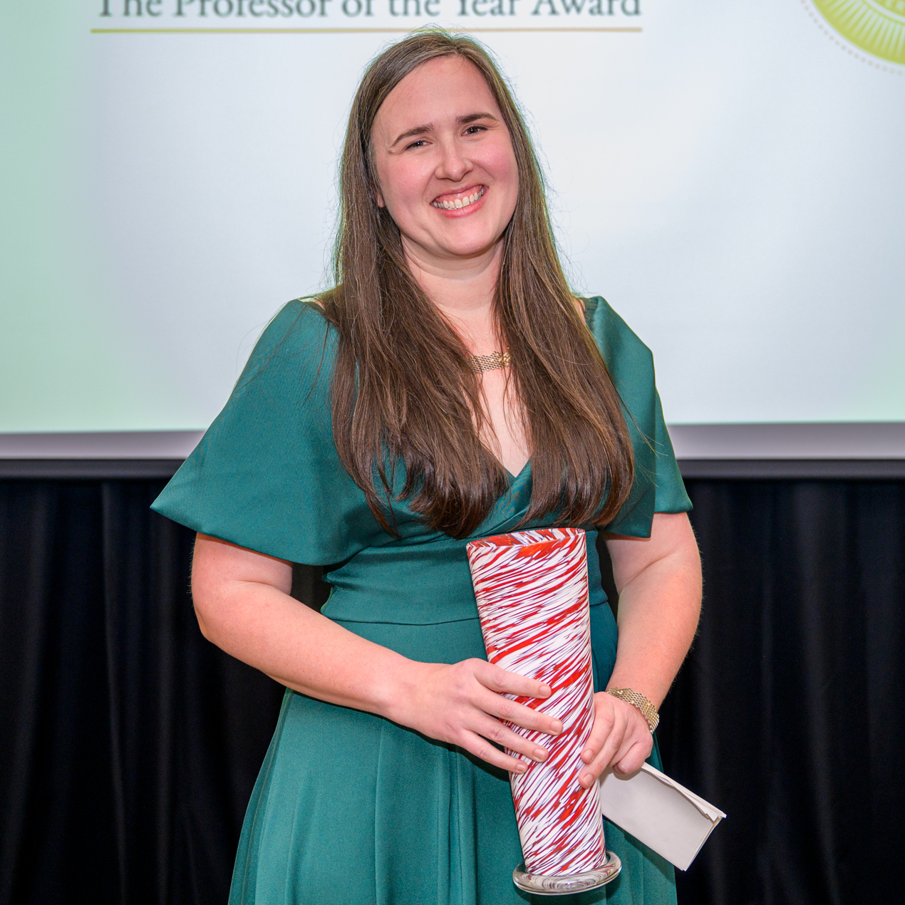 A photo of Dr. Anne Franklin Lamar holding her award.