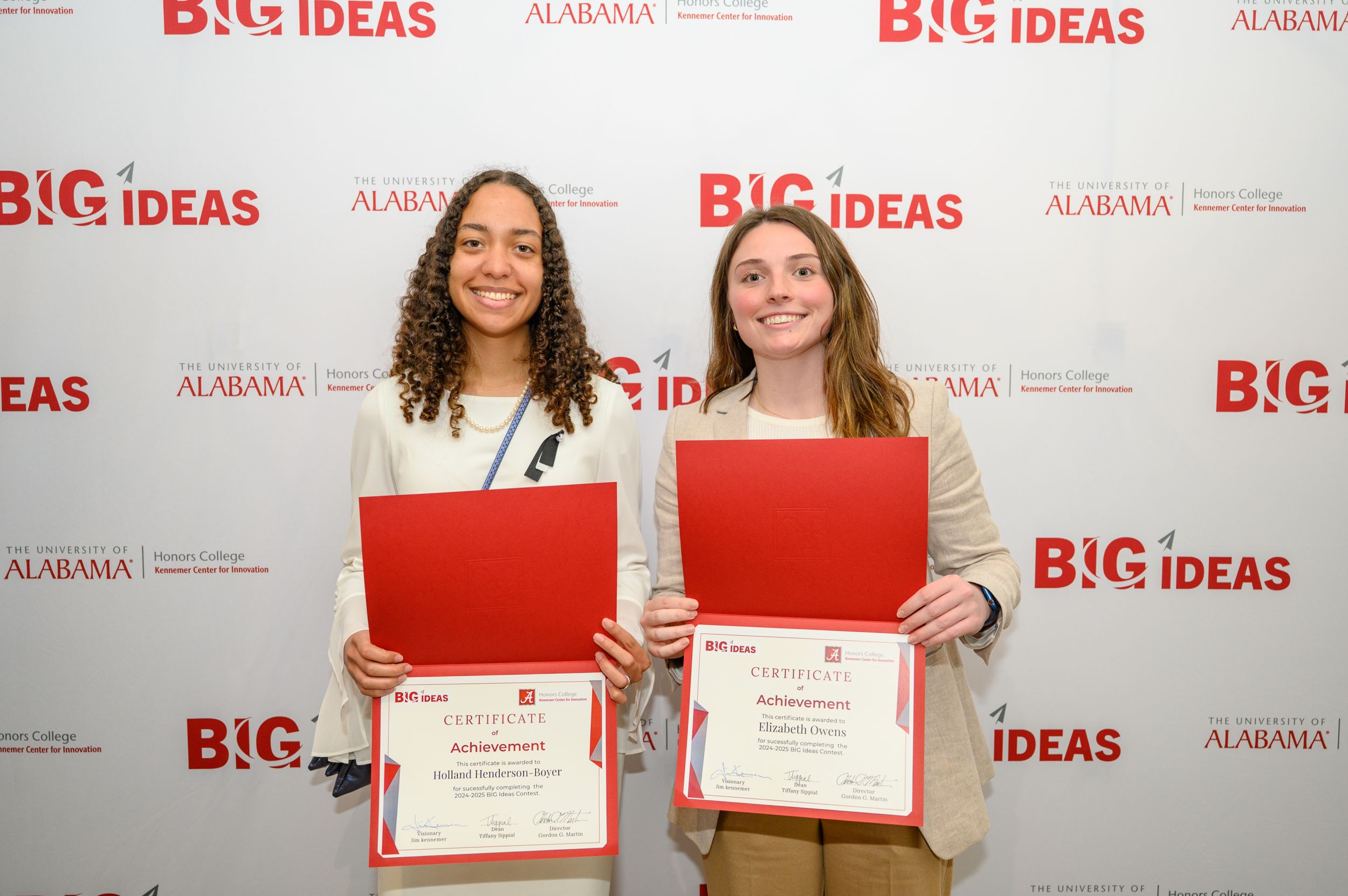 Two BIG Ideas participants smile with their certificates.