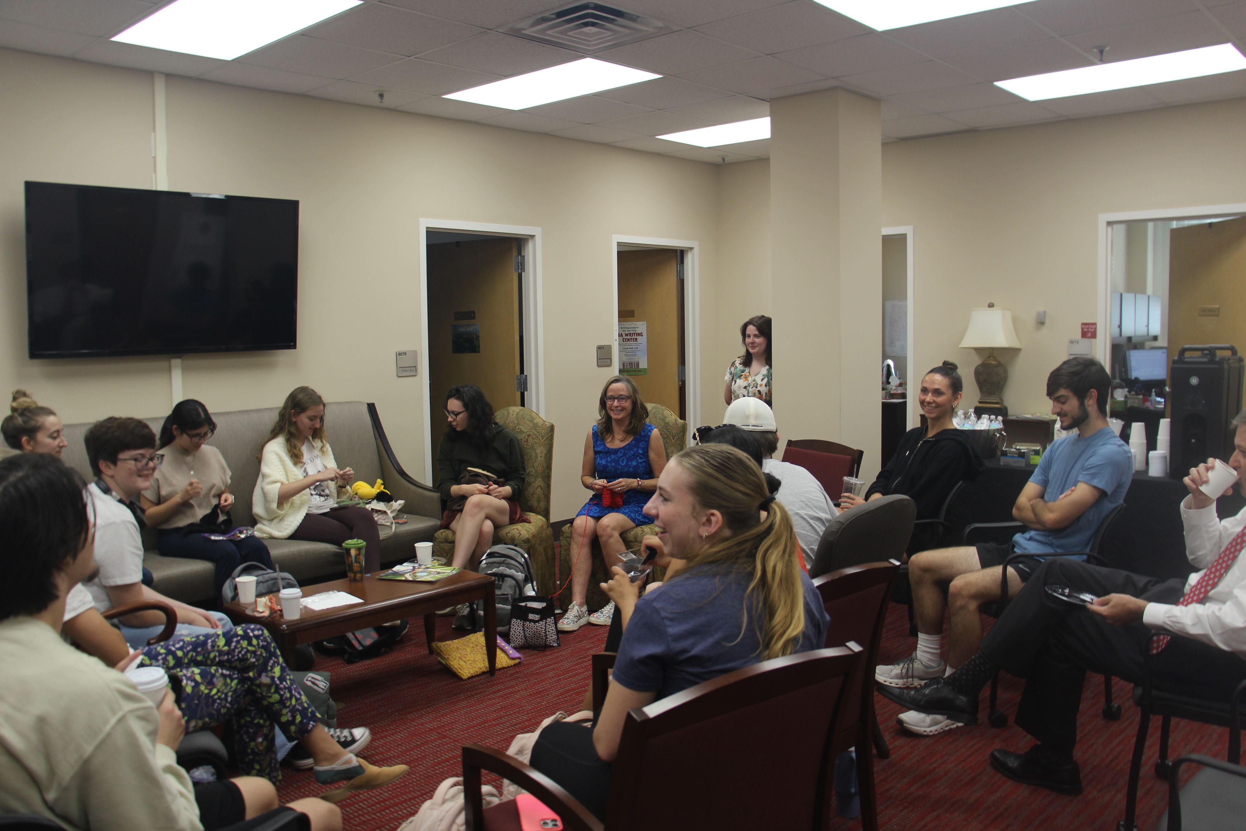 A photo of Trisha O'Kane doing crafts and discussion with Honors students.