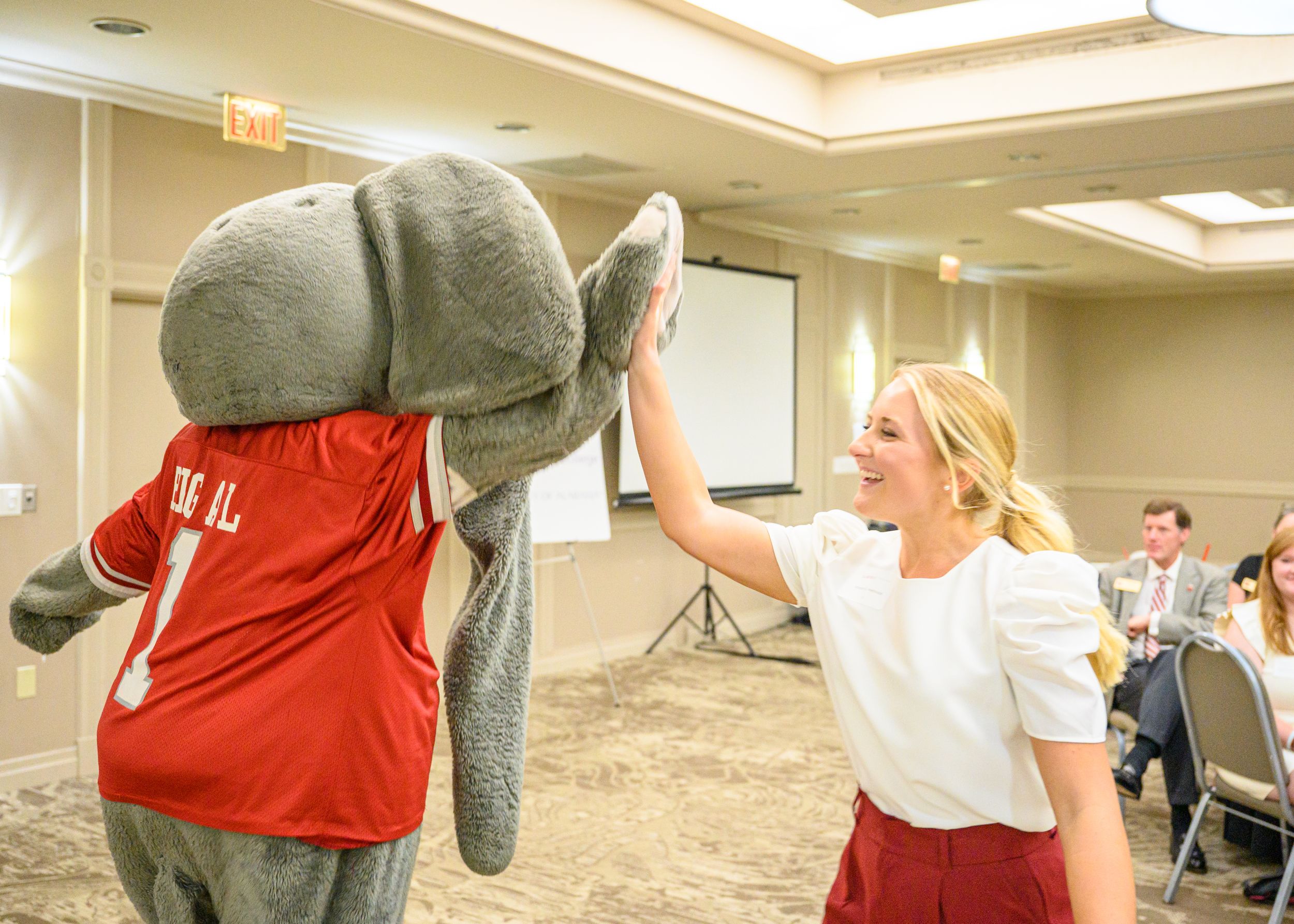 An Honors student high fives Big Al.