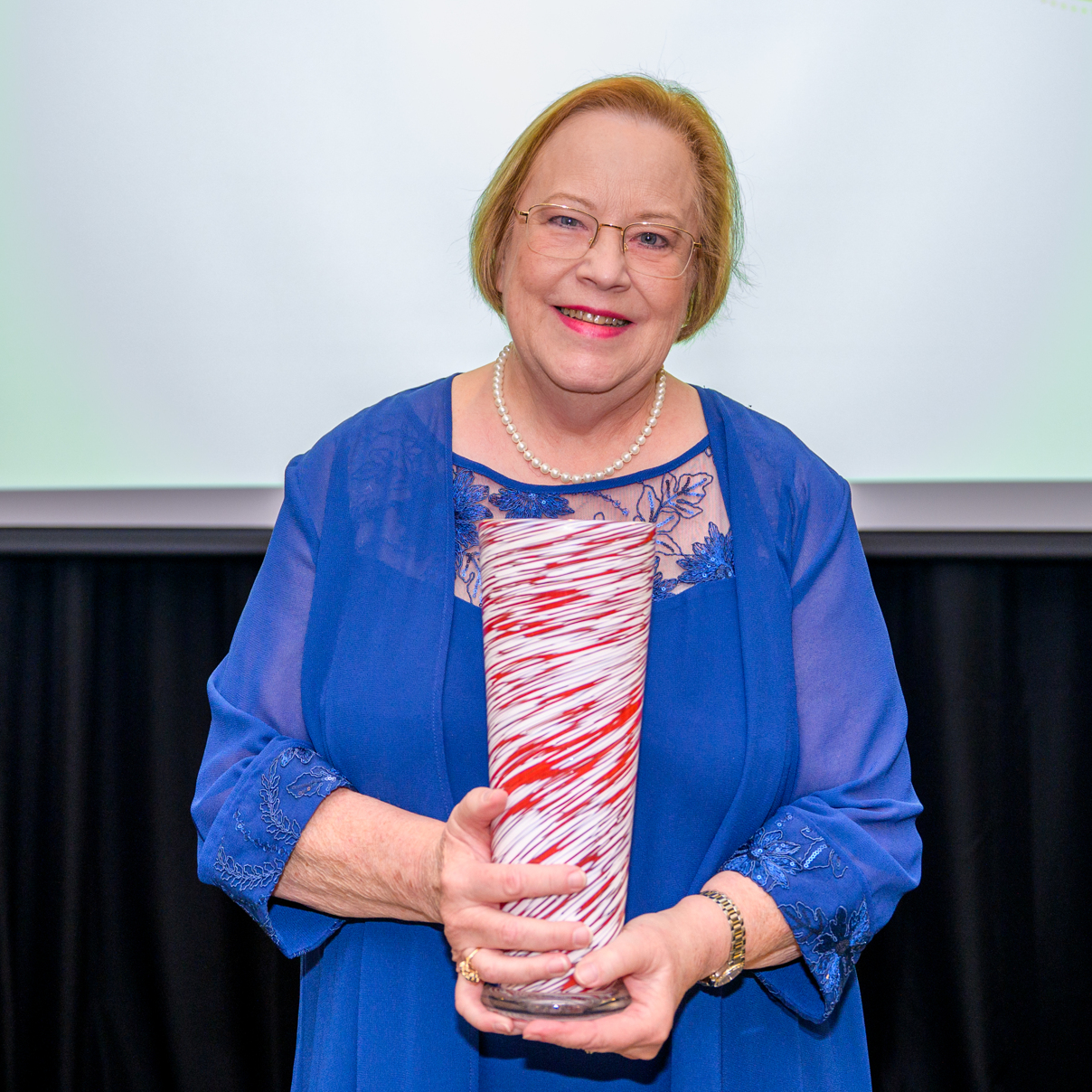 A photo of Jane Batson holding her award.