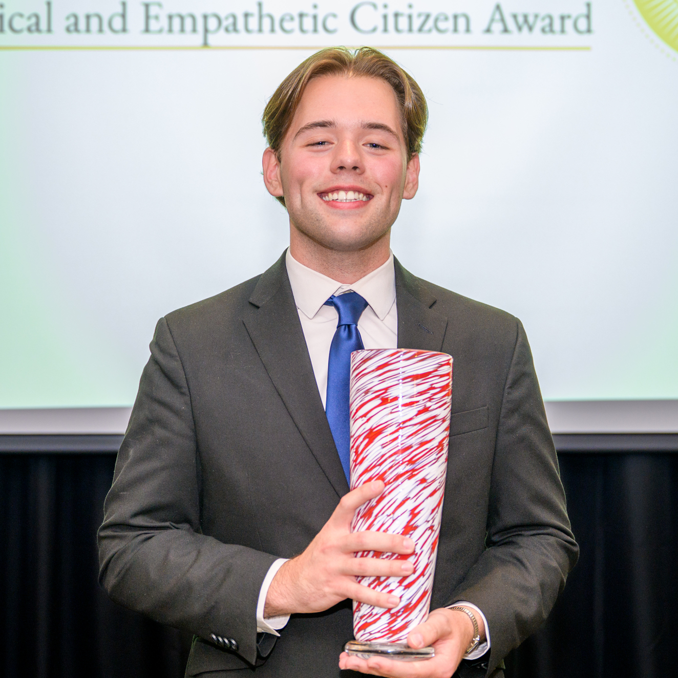 A photo of Caleb Buell holding his award.