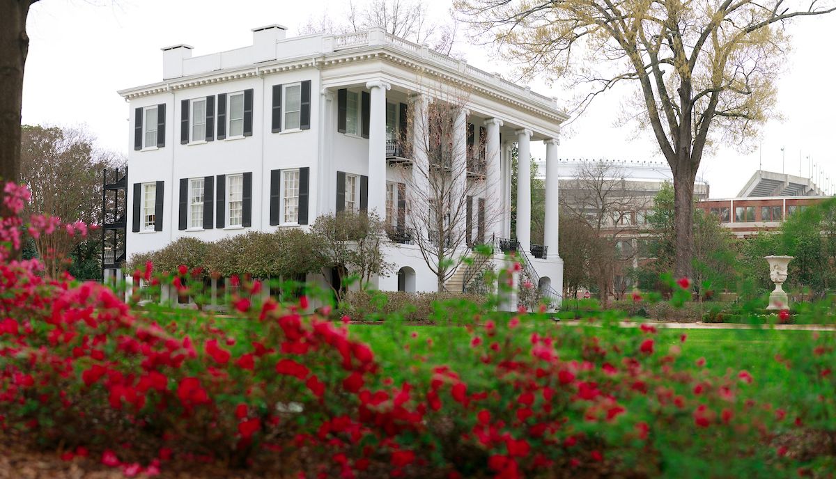 President's Mansion in the background with views of red azaleas in the foreground.