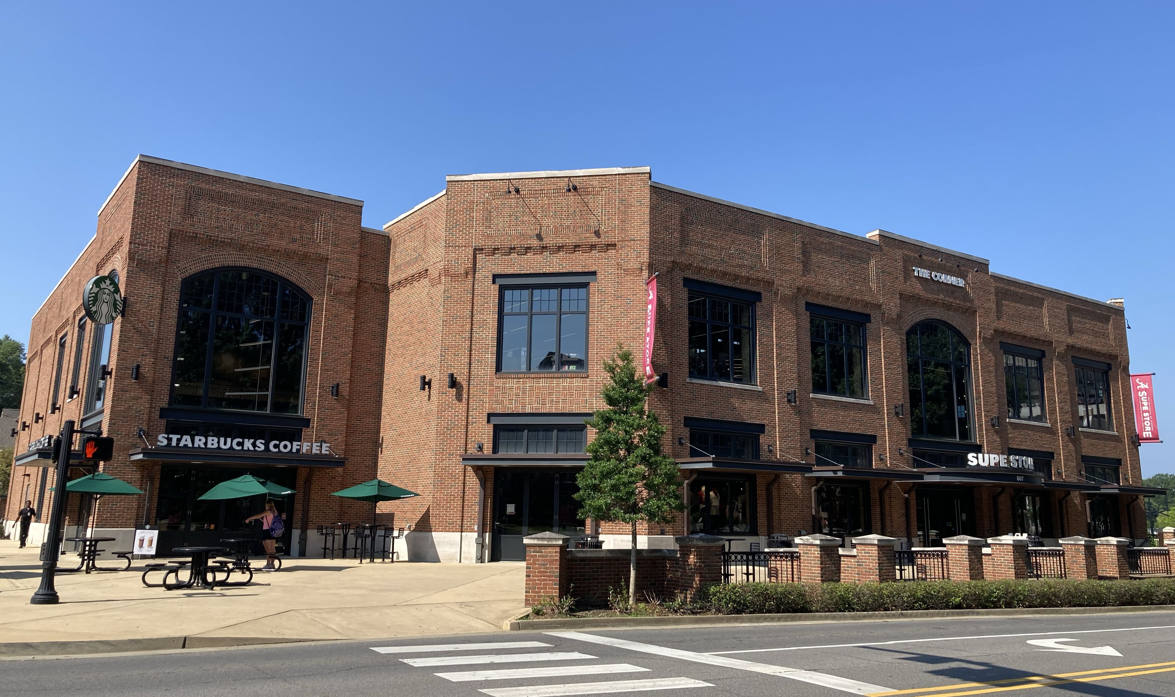 Exterior shot from across the street of The Corner building that houses Starbucks and the Supe Store.