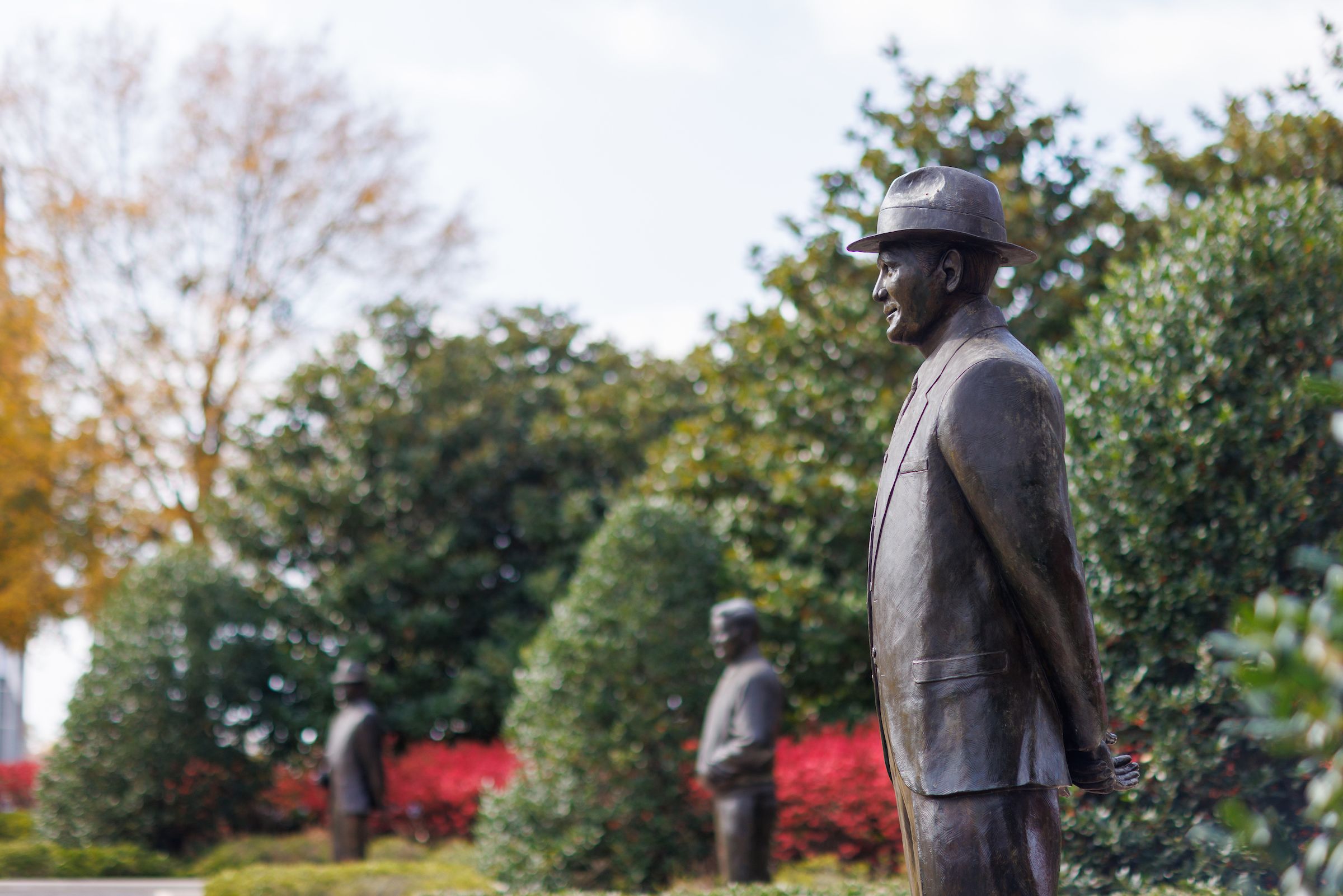 Statues of championship football coaches in the Walk of Champions outside the stadium.