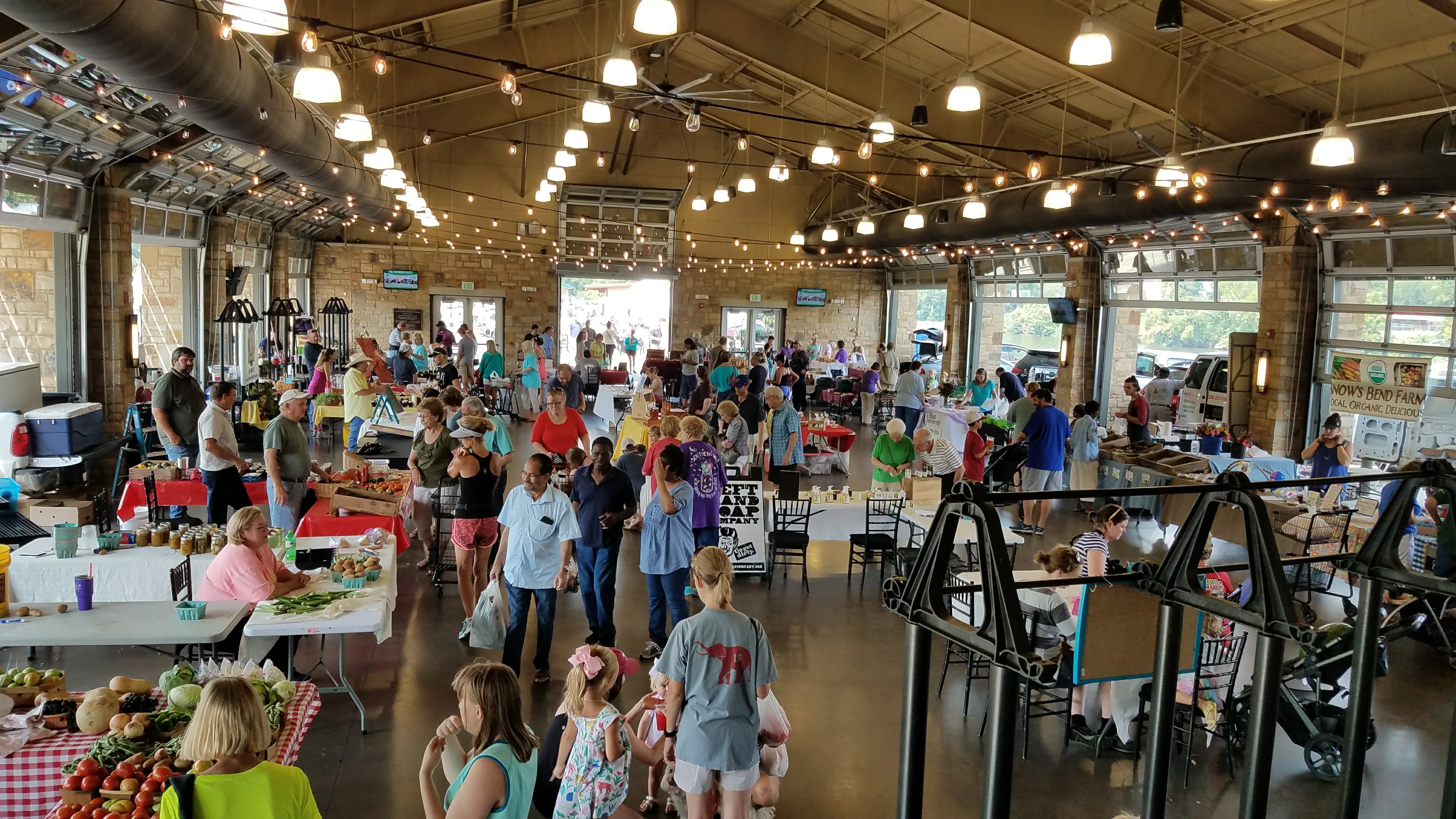 Patrons and vendors mingle at the Farmers Market.